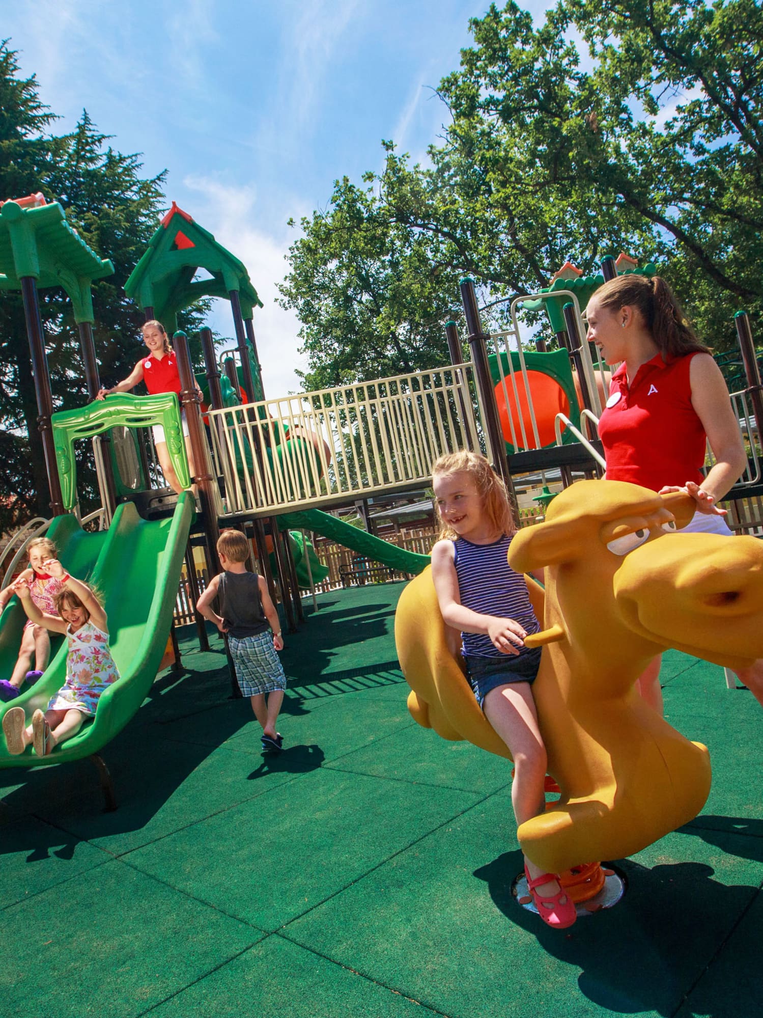 a woman and kids at a playground