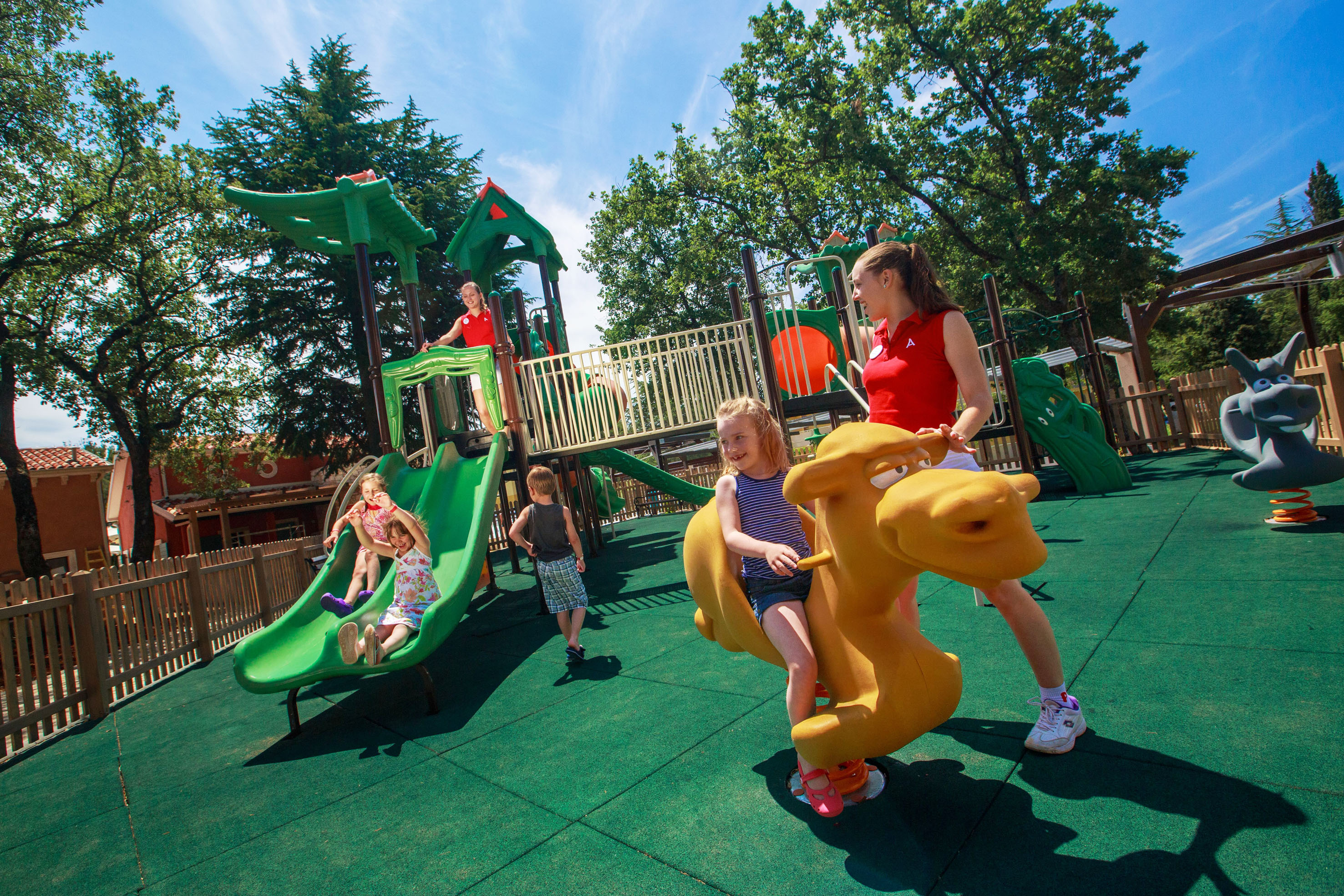 a woman and kids at a playground