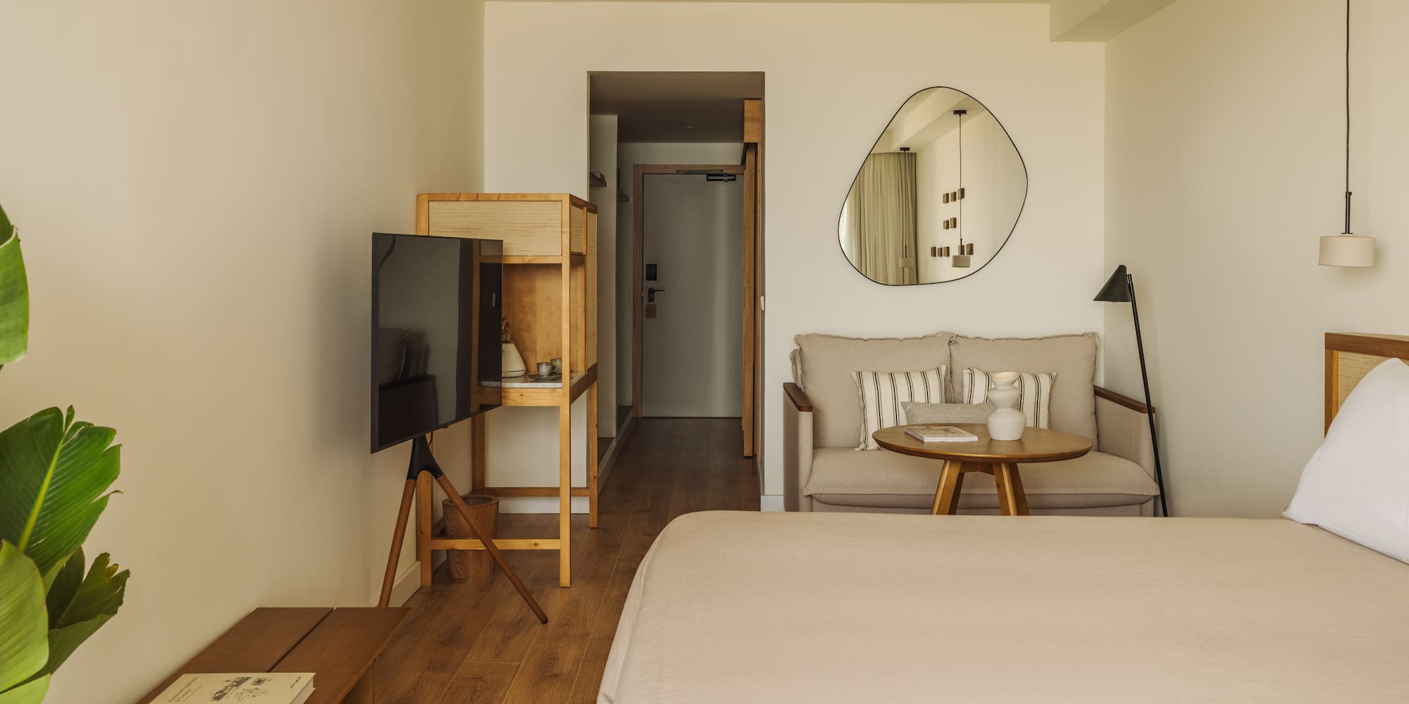 a room with a bed and a television