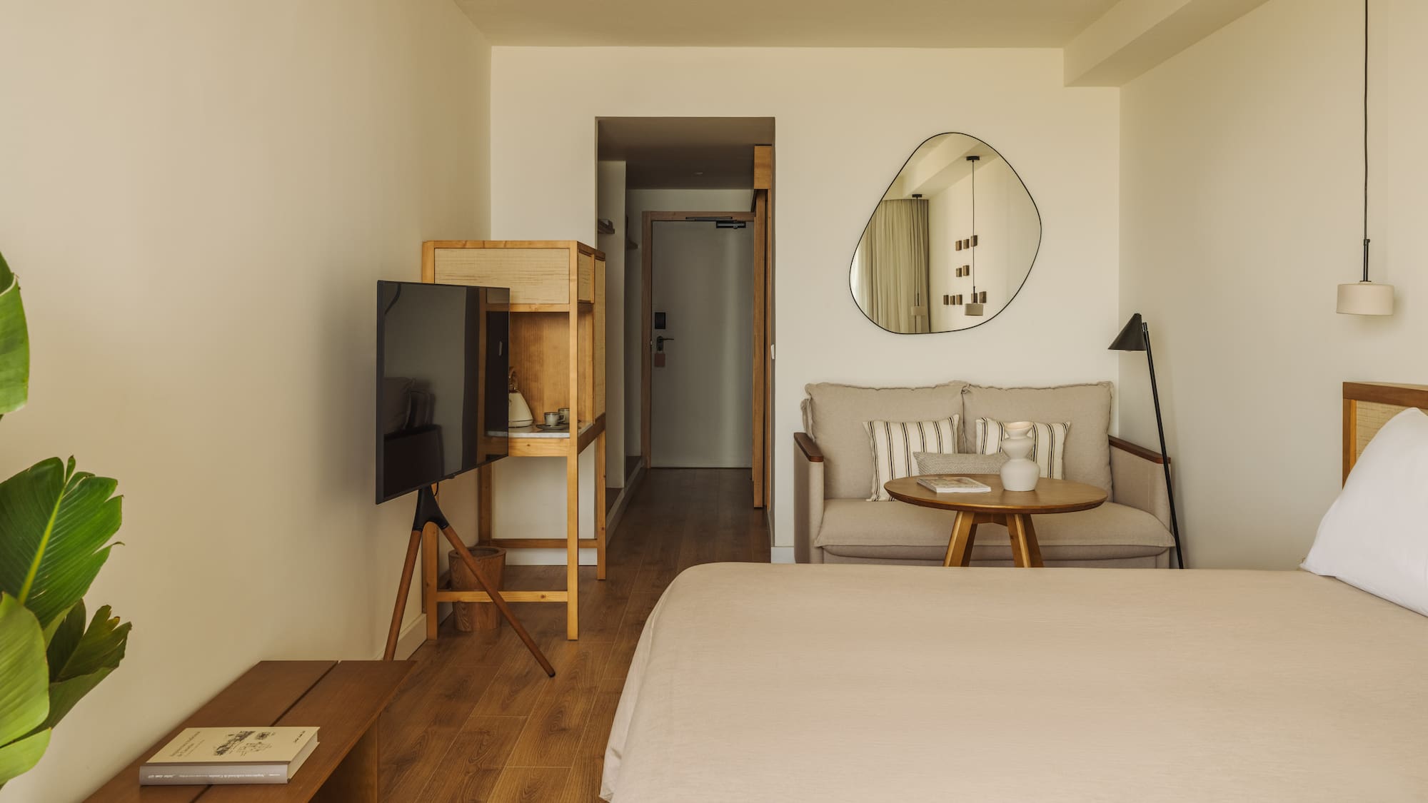 a room with a bed and a television