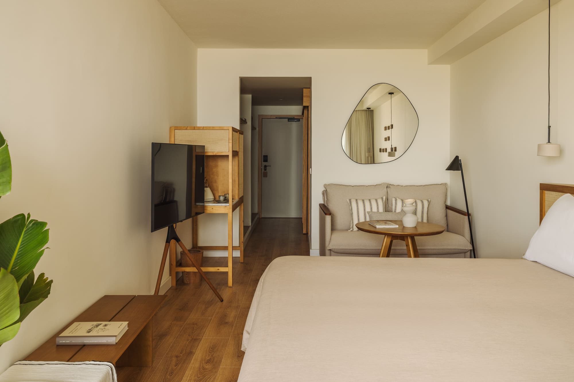 a room with a bed and a television