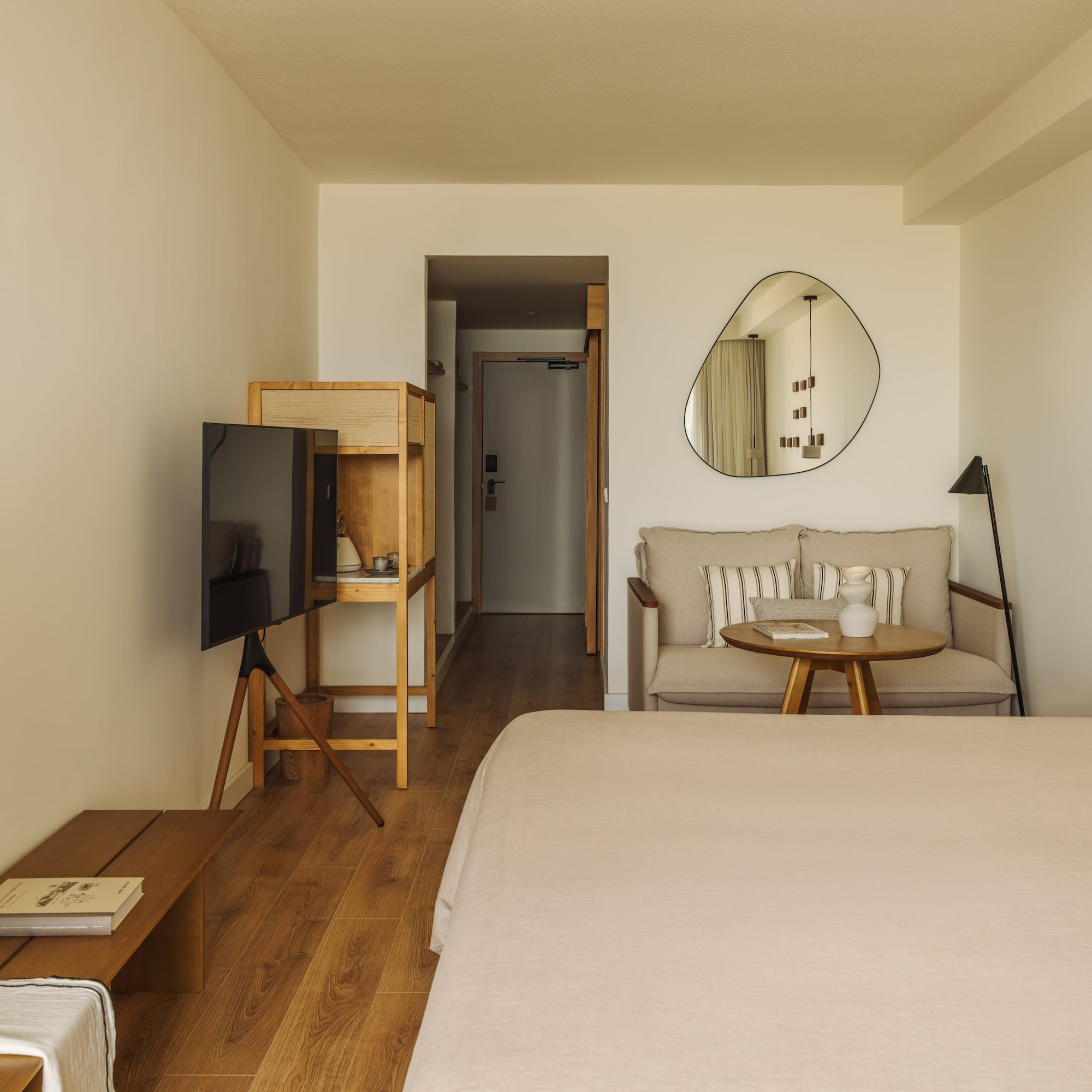 a room with a bed and a television