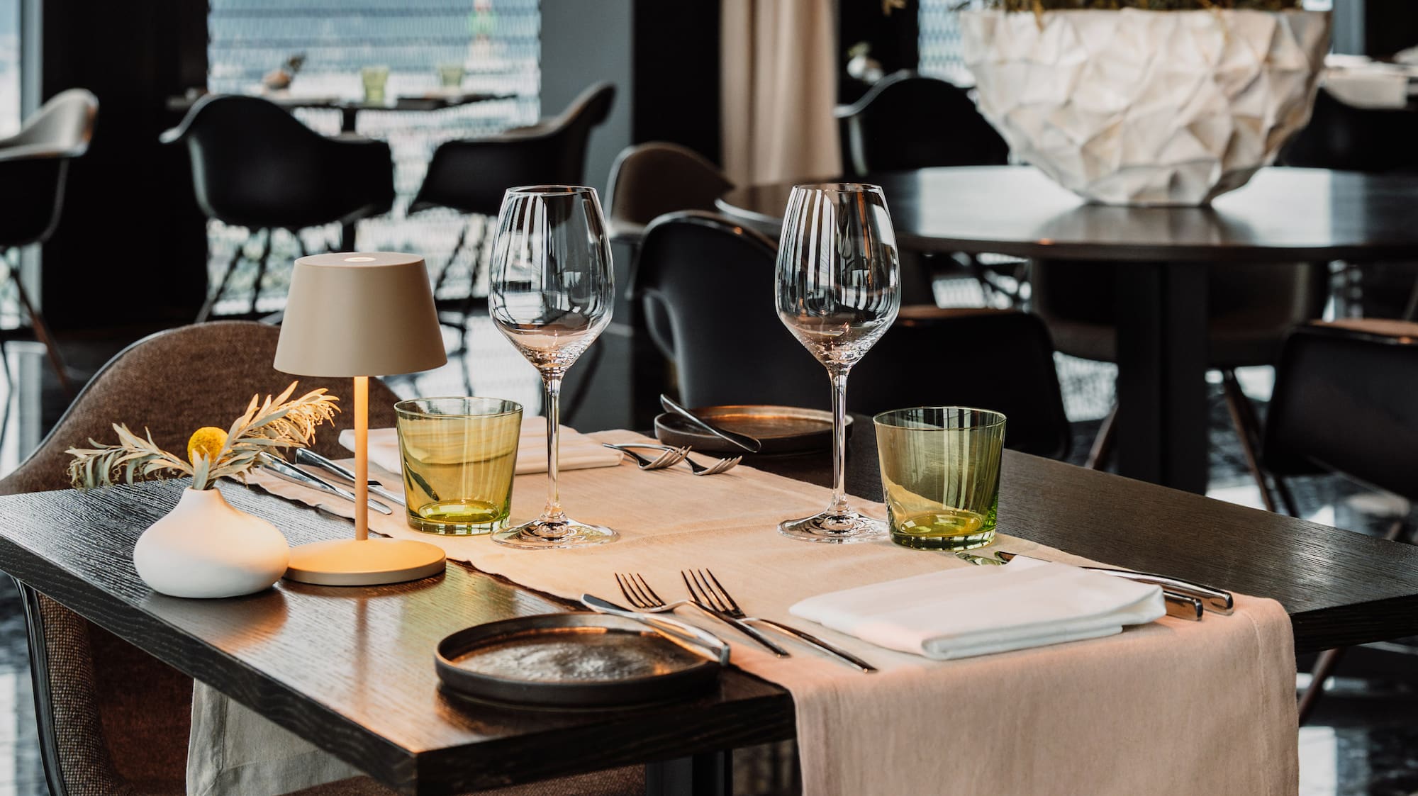 a table with glasses and napkins on it