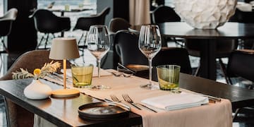 a table with glasses and napkins on it