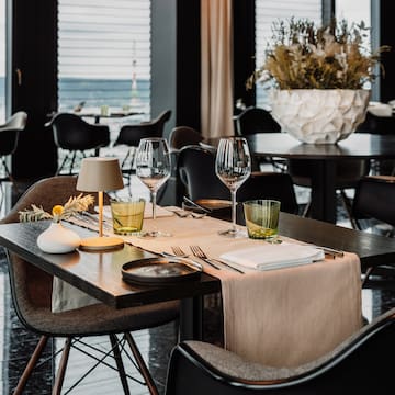 a table with glasses and napkins on it