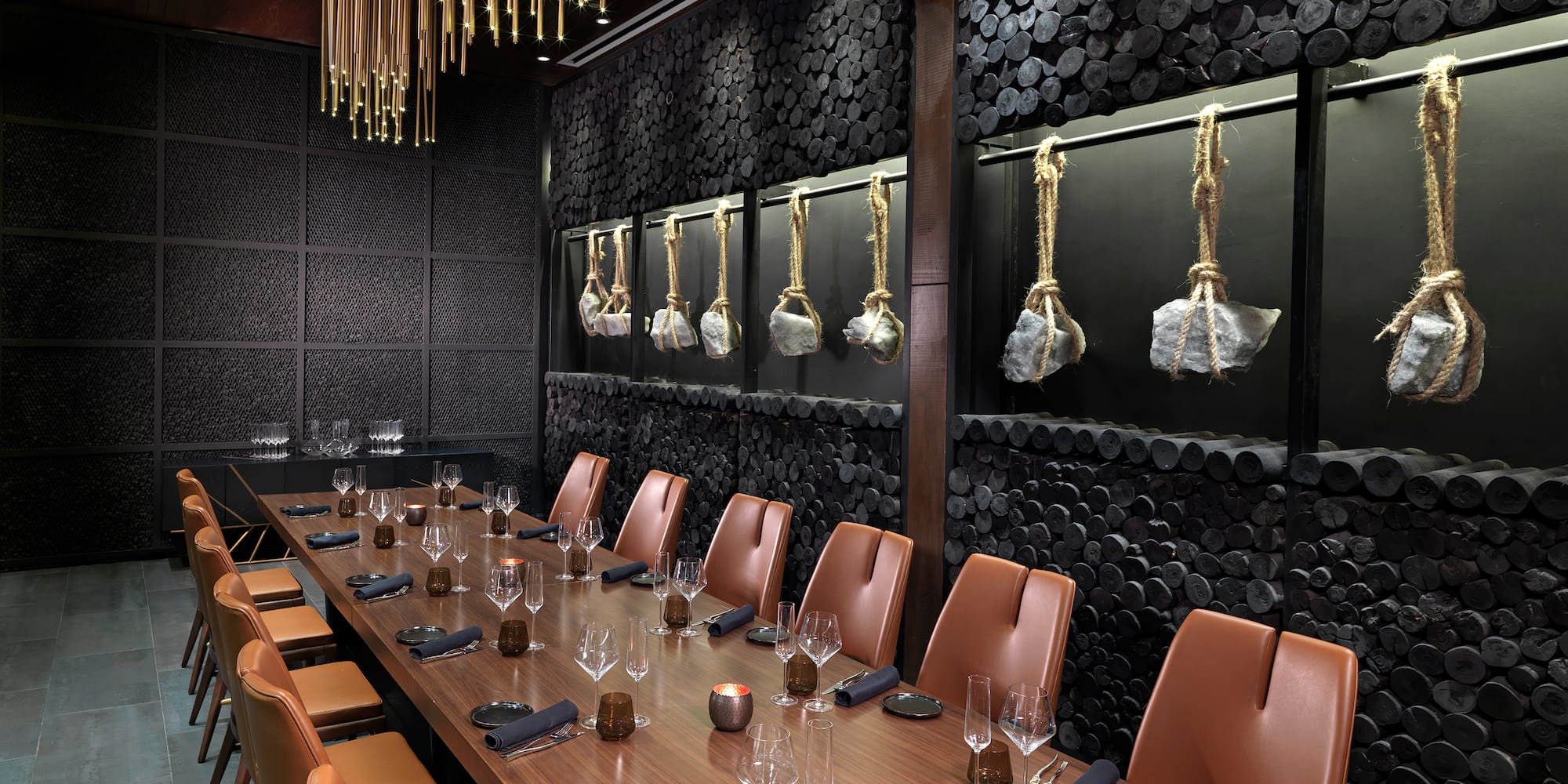 a long table with chairs and glasses