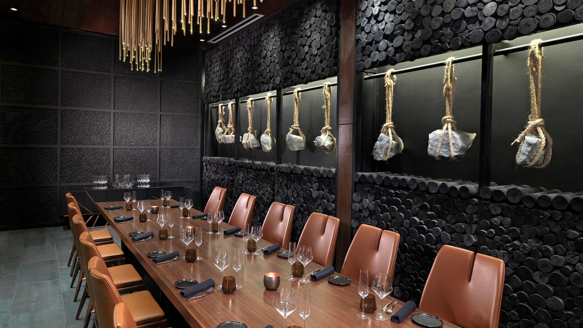 a long table with chairs and glasses