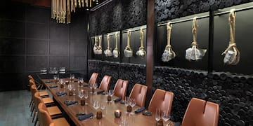 a long table with chairs and glasses