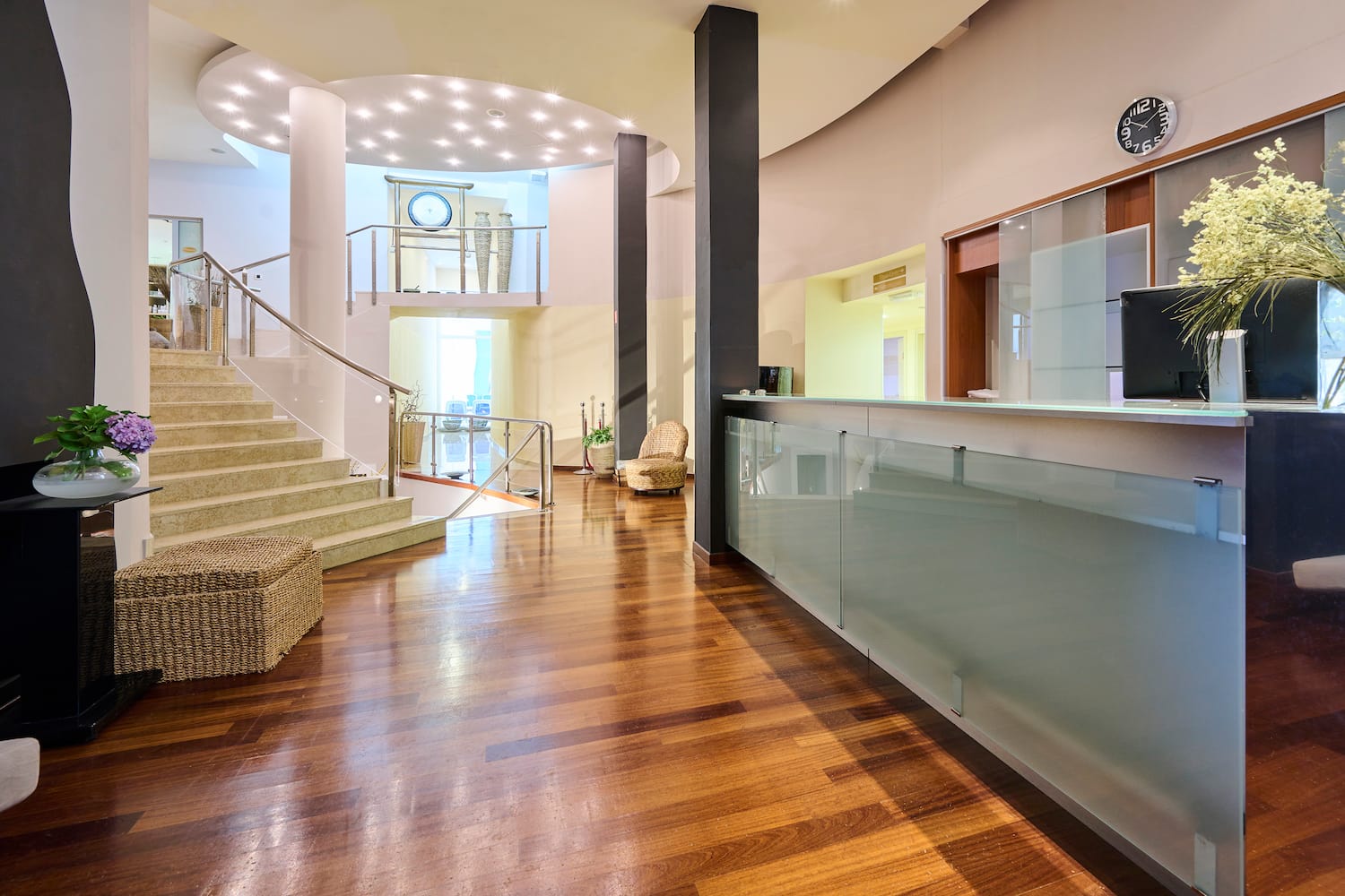 a lobby with a glass wall and stairs