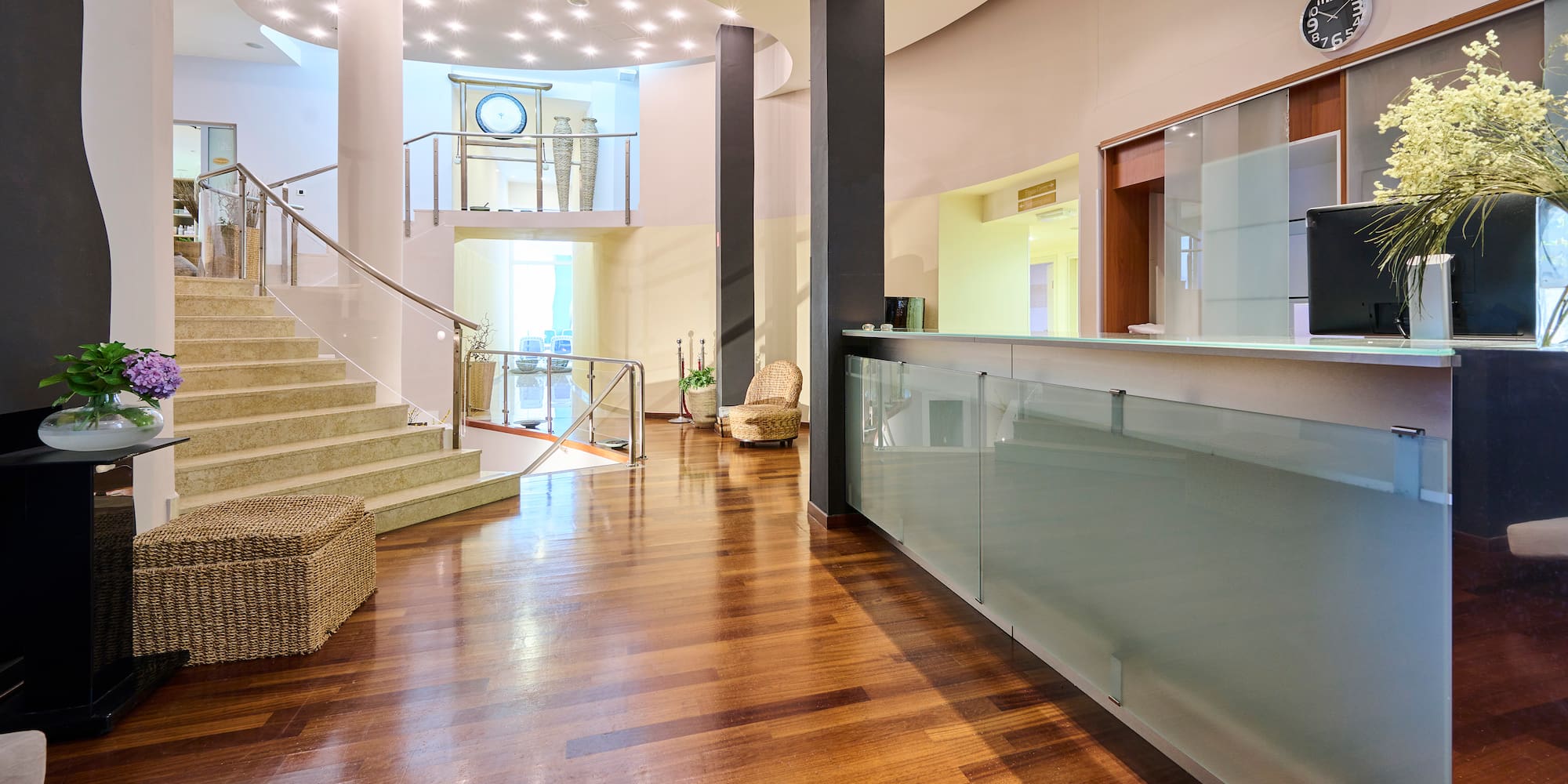 a lobby with a glass wall and stairs
