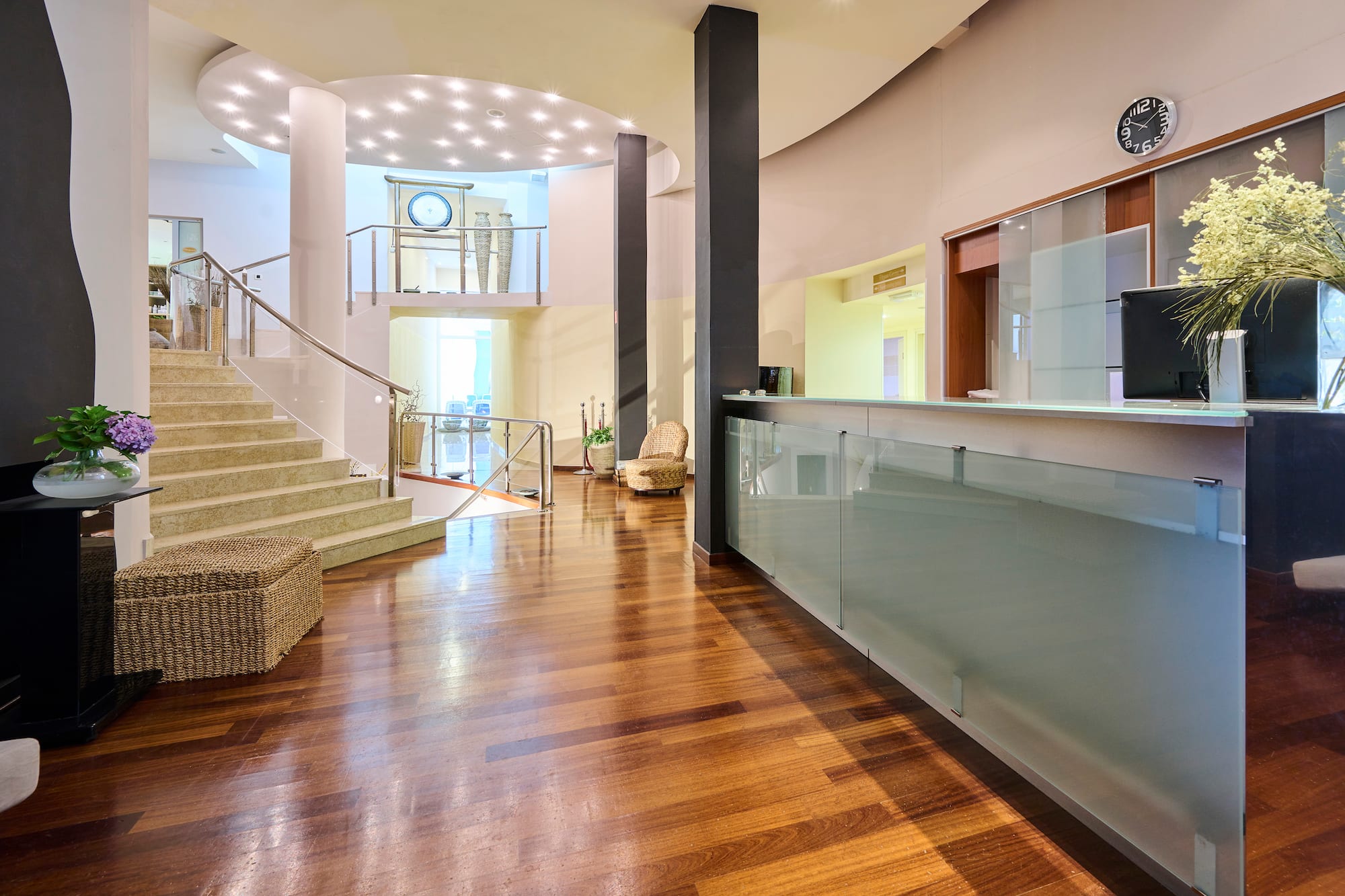 a lobby with a glass wall and stairs