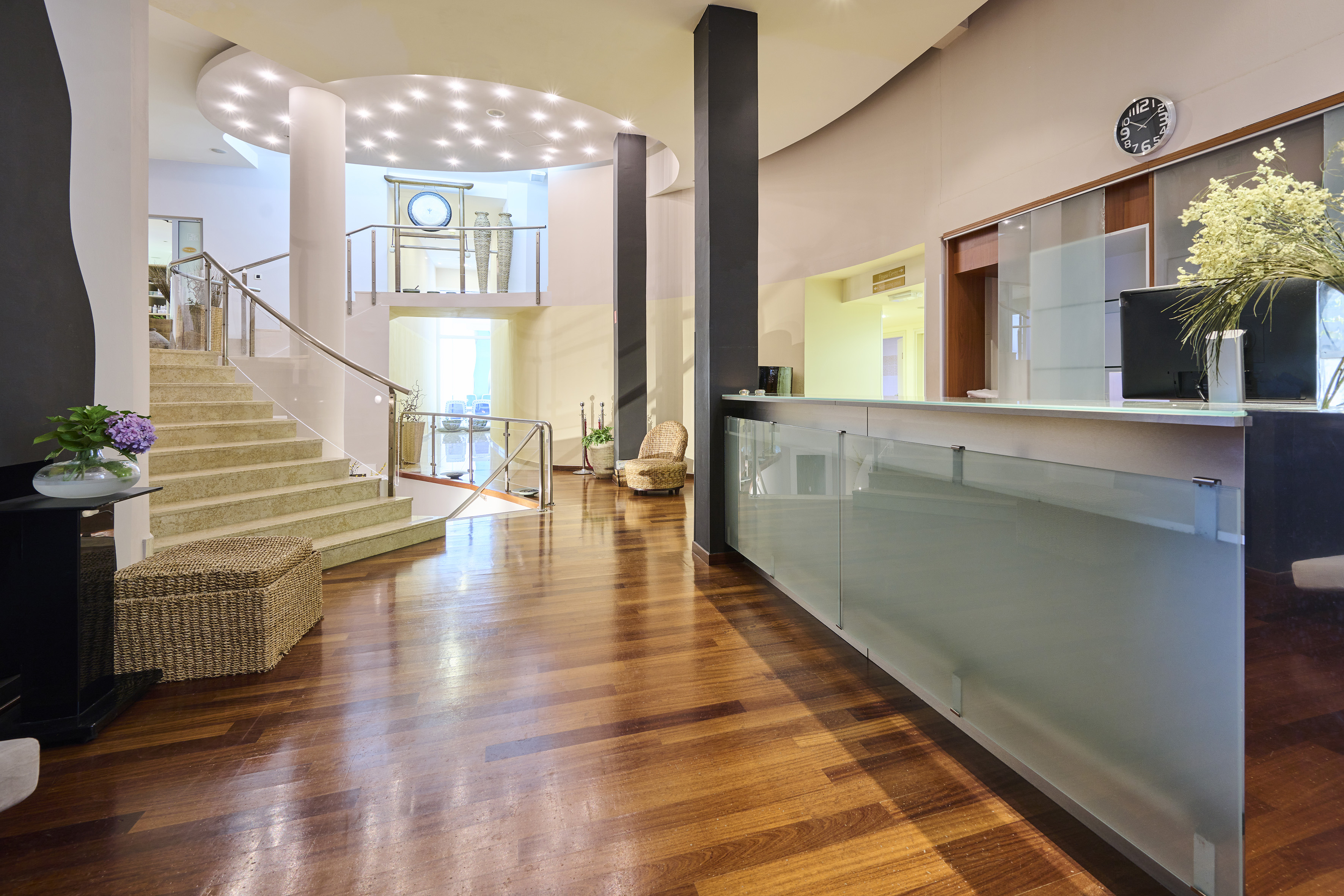 a lobby with a glass wall and stairs