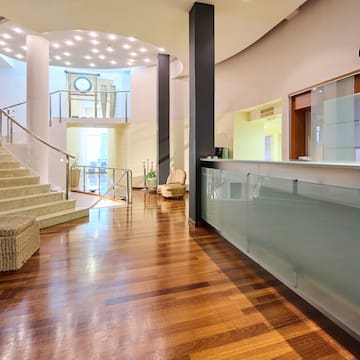 a lobby with a glass wall and stairs