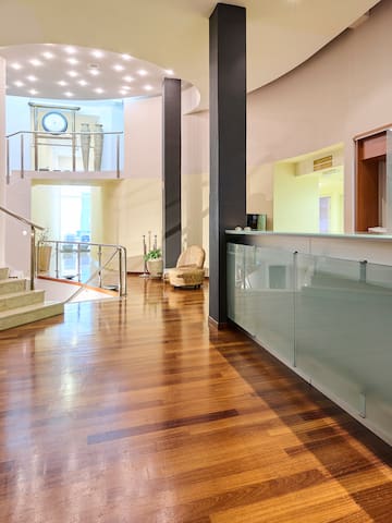 a lobby with a glass wall and stairs
