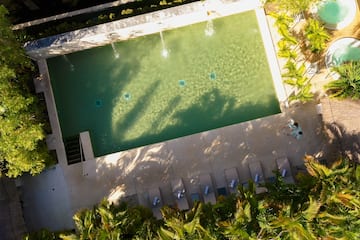 a pool with water jets and trees