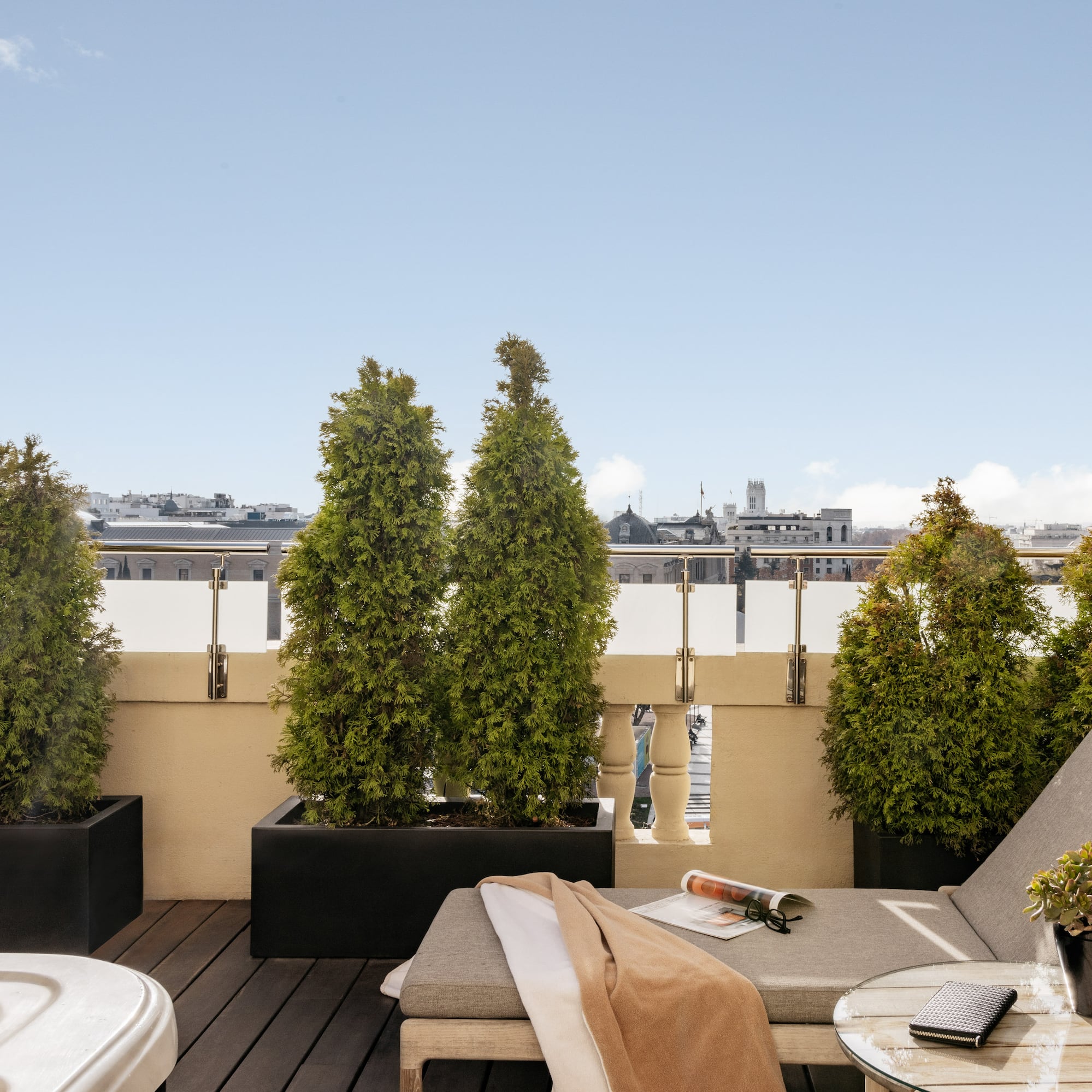 a deck with a chair and a hot tub and trees