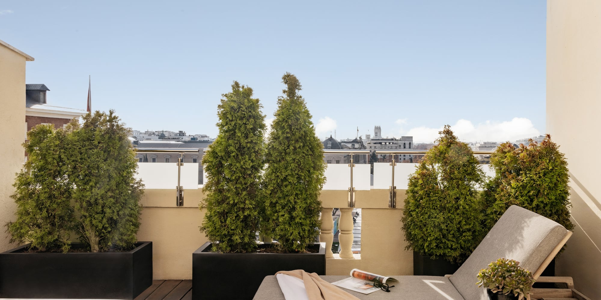 a deck with a chair and a hot tub and trees