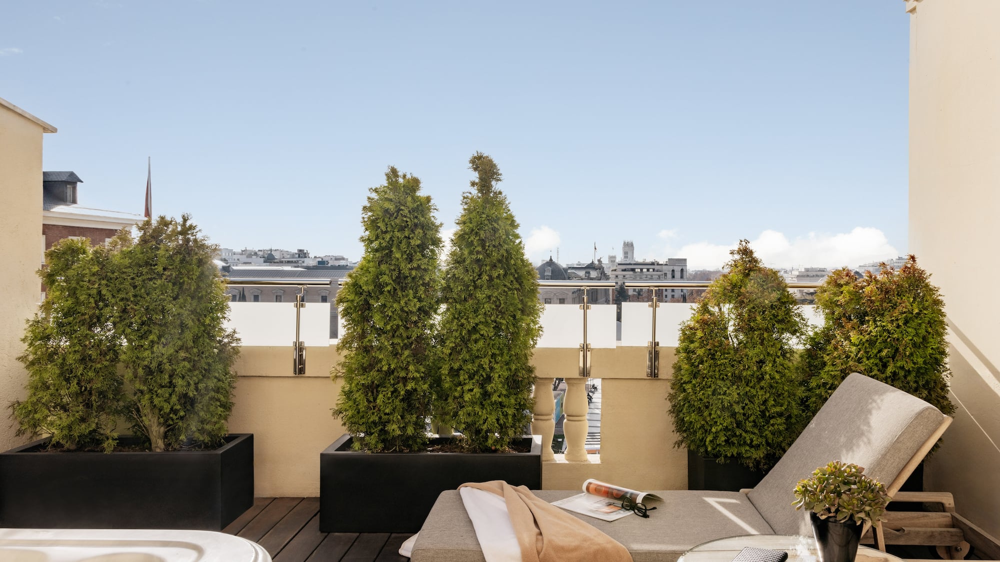 a deck with a chair and a hot tub and trees