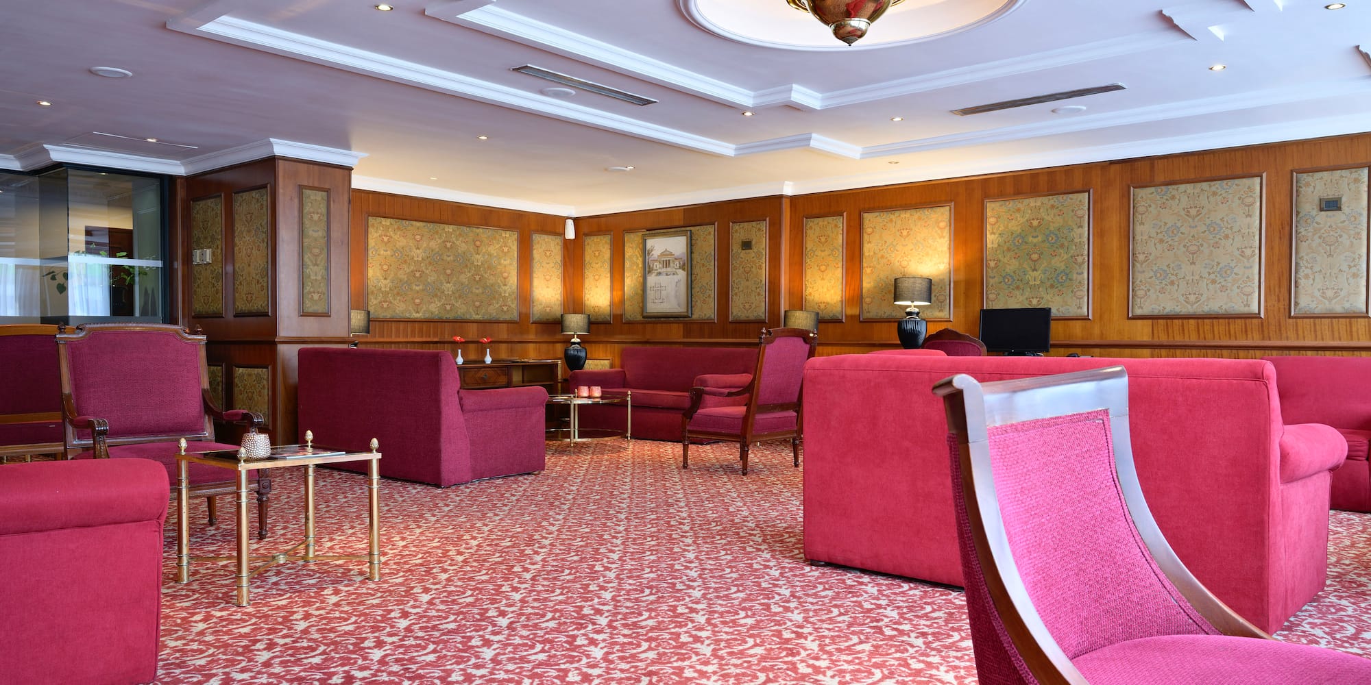 a room with pink chairs and tables