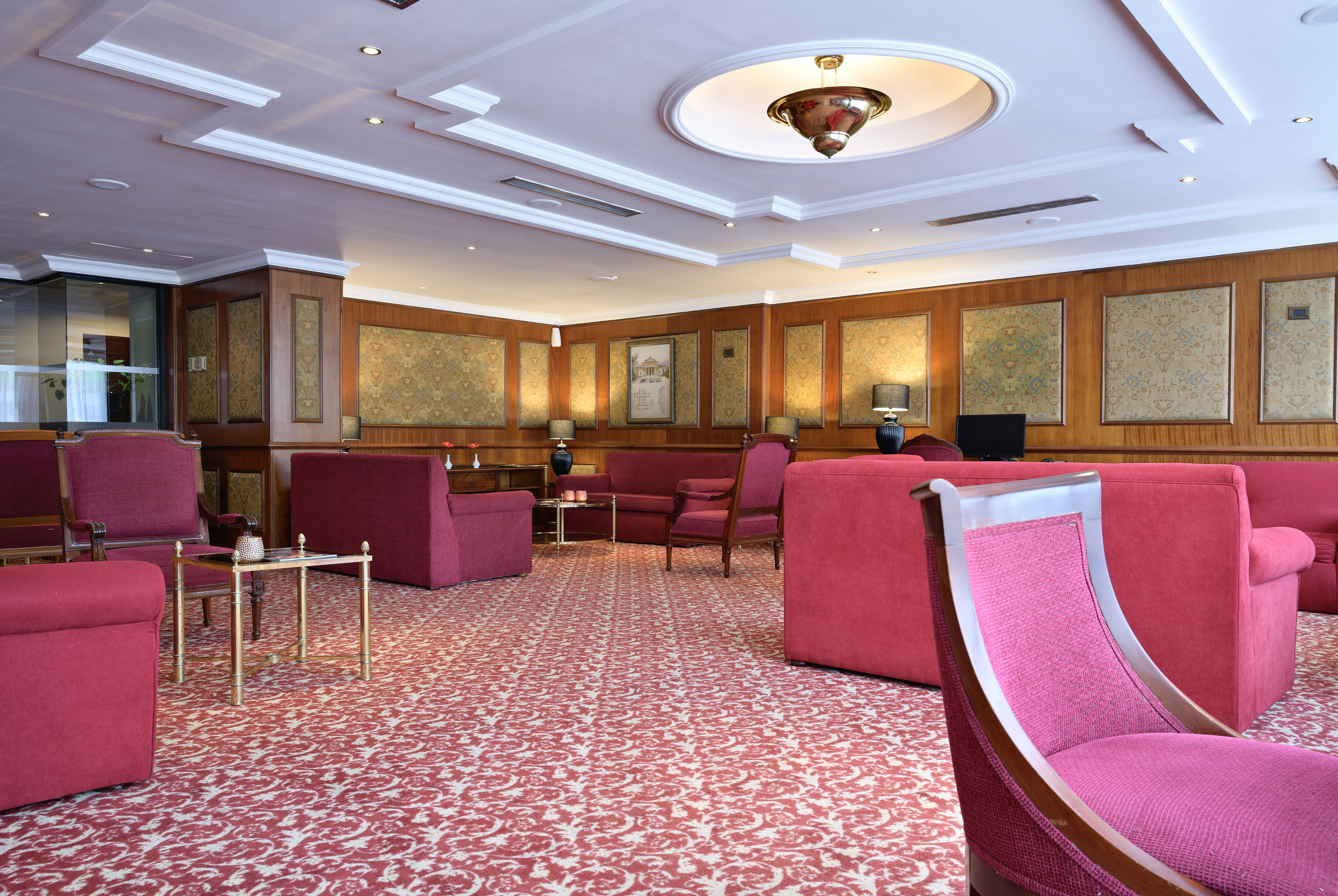 a room with pink chairs and tables