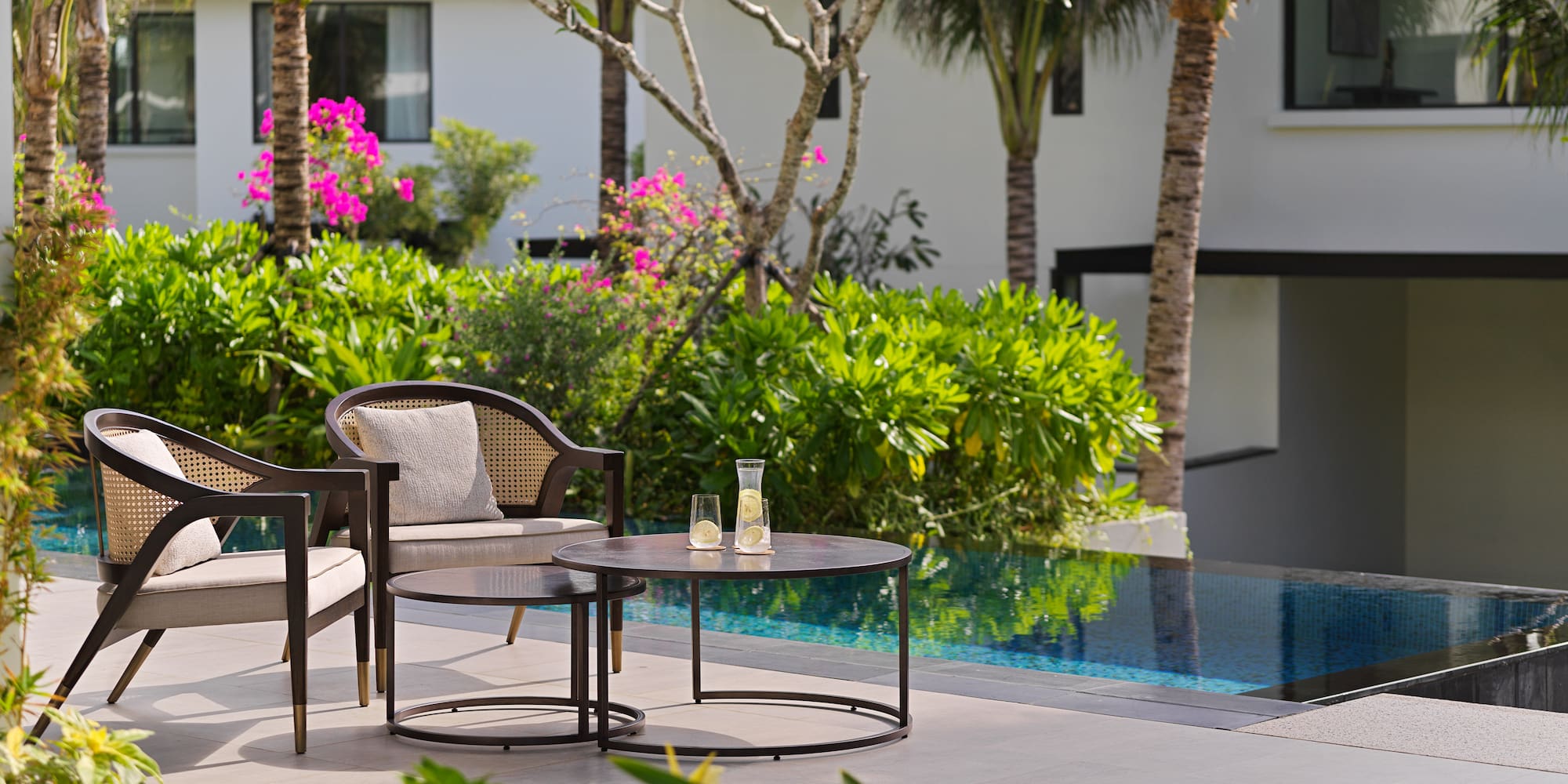 a chair and table by a pool