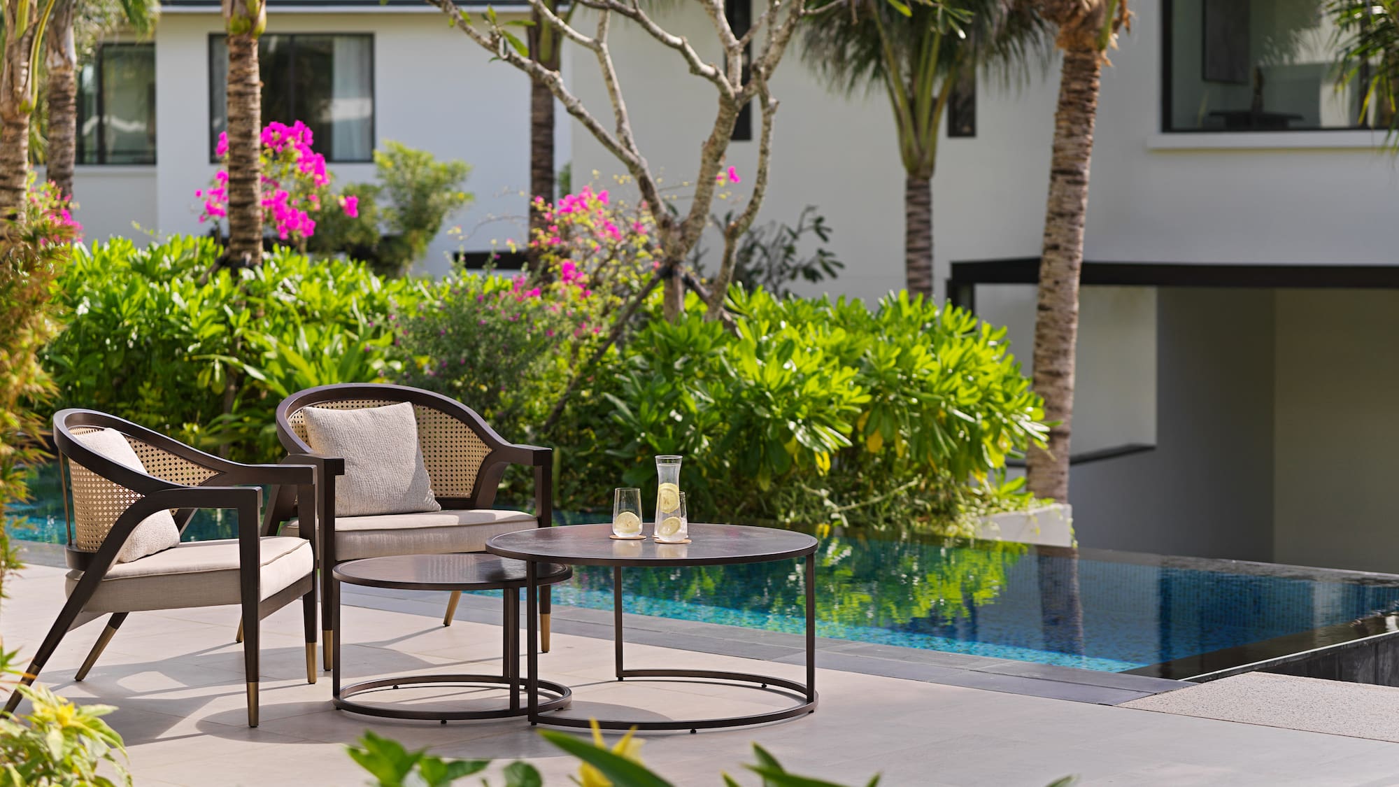 a chair and table by a pool