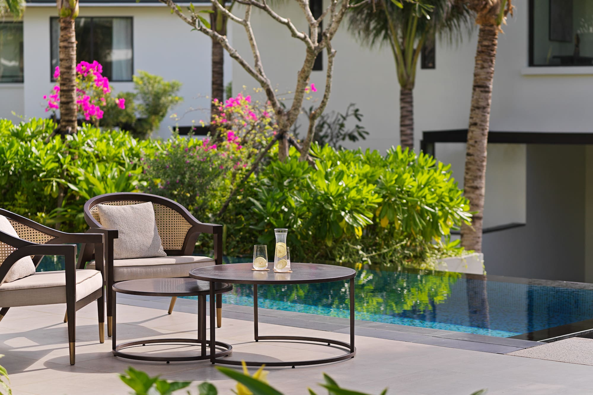 a chair and table by a pool