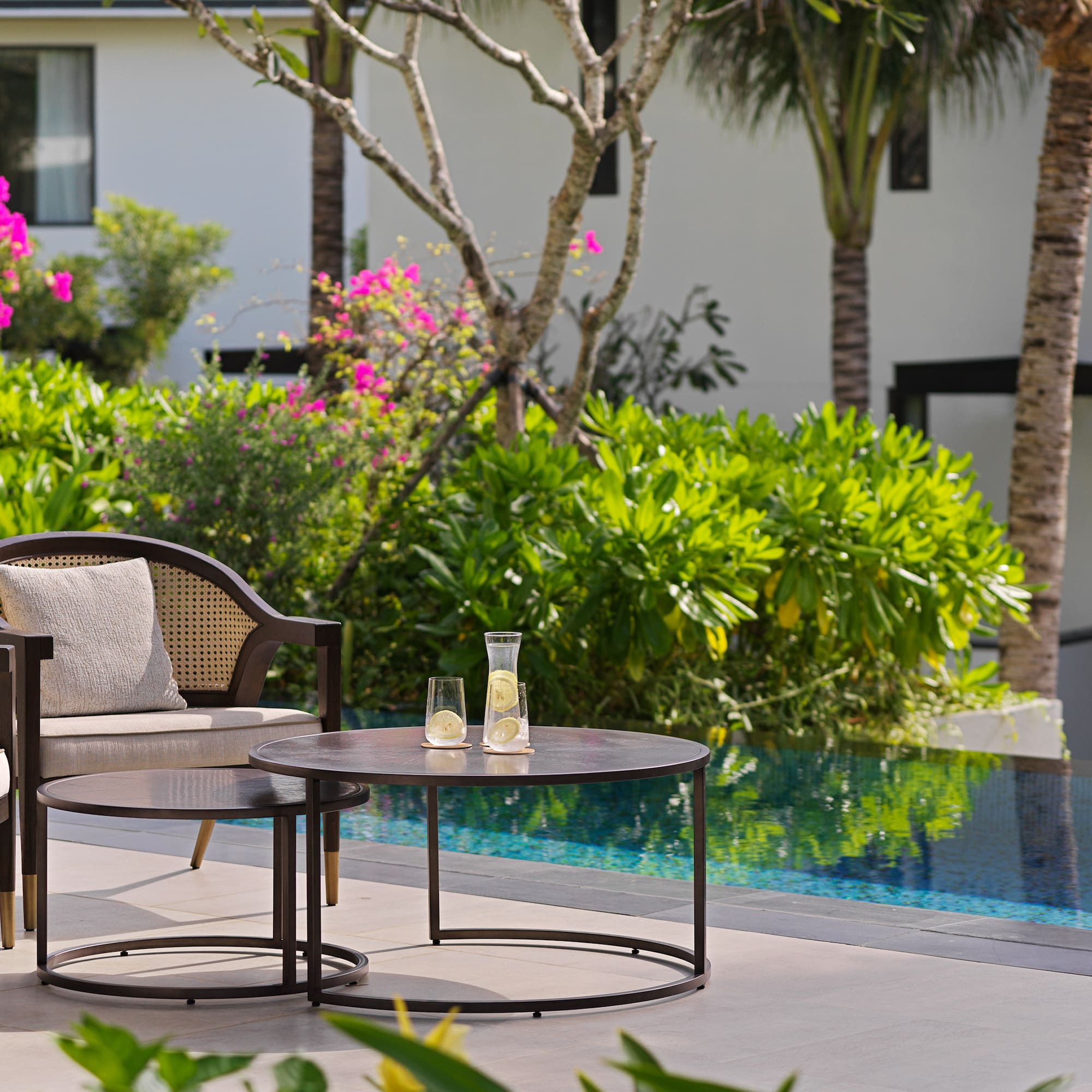 a chair and table by a pool