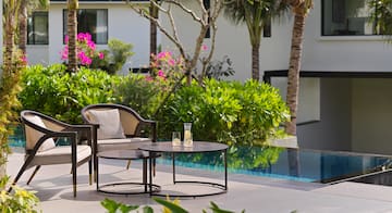 a chair and table by a pool