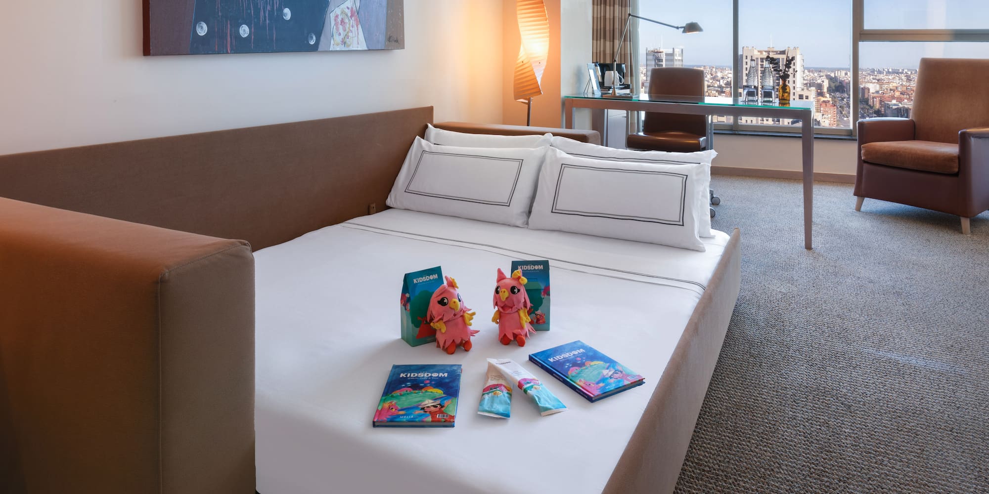 a bed with a couple of stuffed animals on it