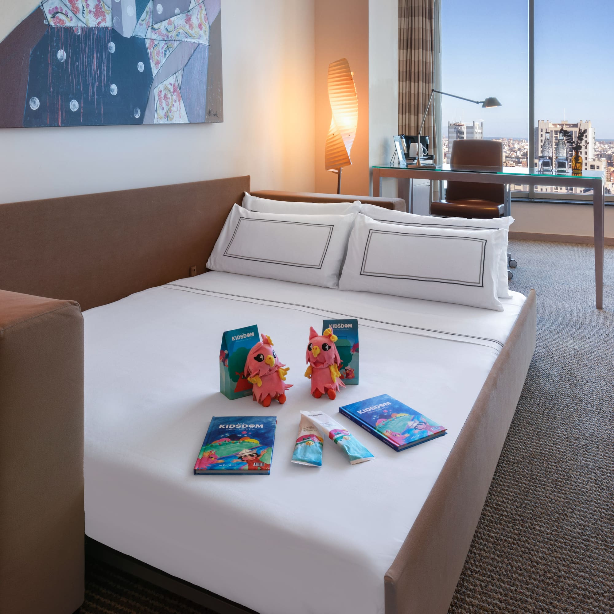 a bed with a couple of stuffed animals on it