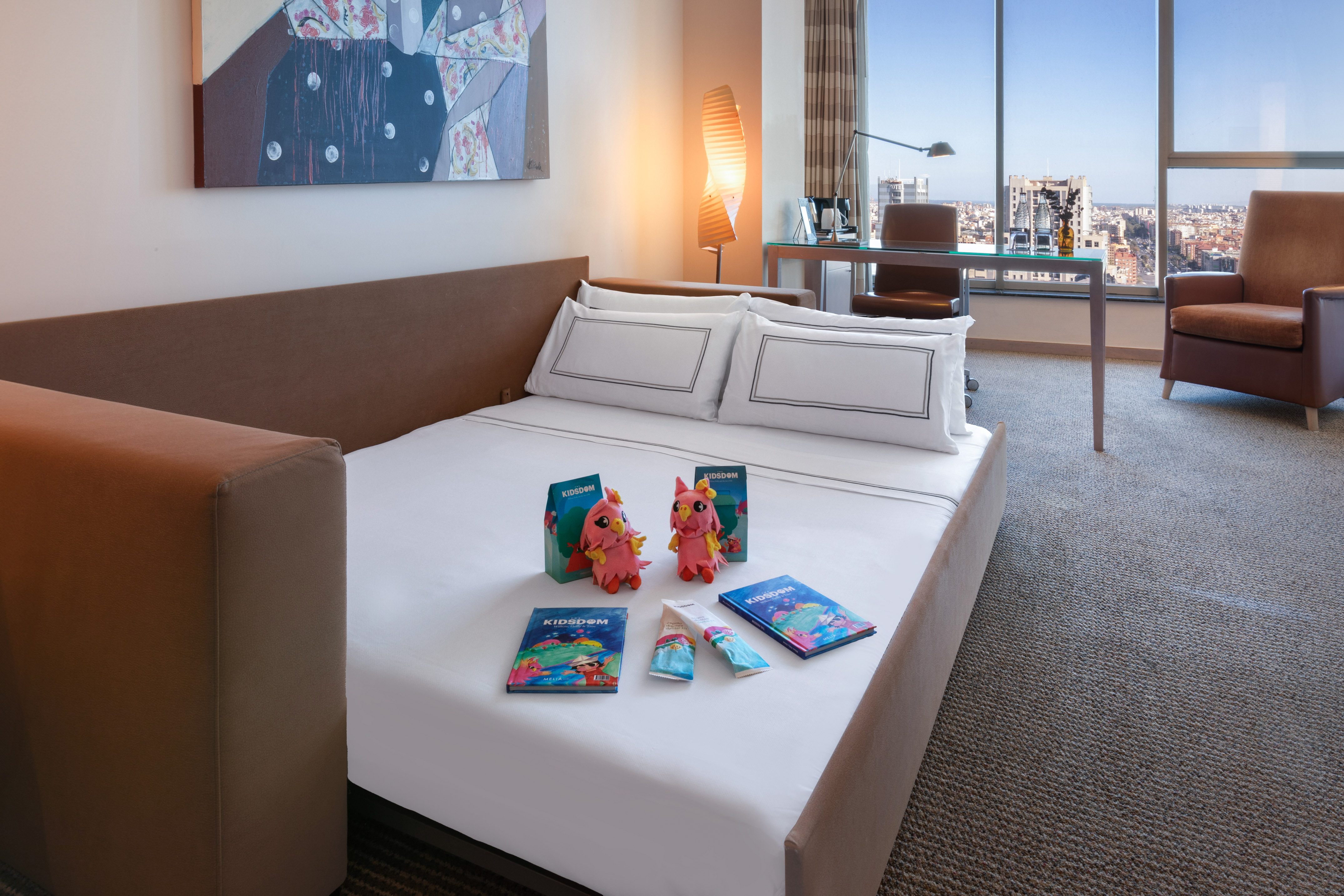 a bed with a couple of stuffed animals on it