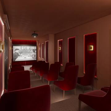 a room with red chairs and a projector screen