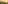 Rooftop lounge with artificial grass, city skyline, and sunset over the sea.