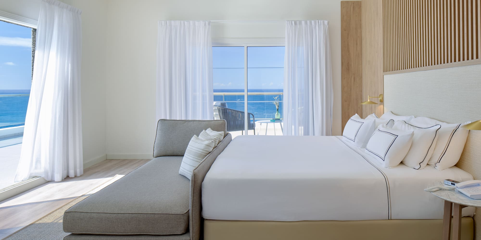 a bed in a room with a couch and a window