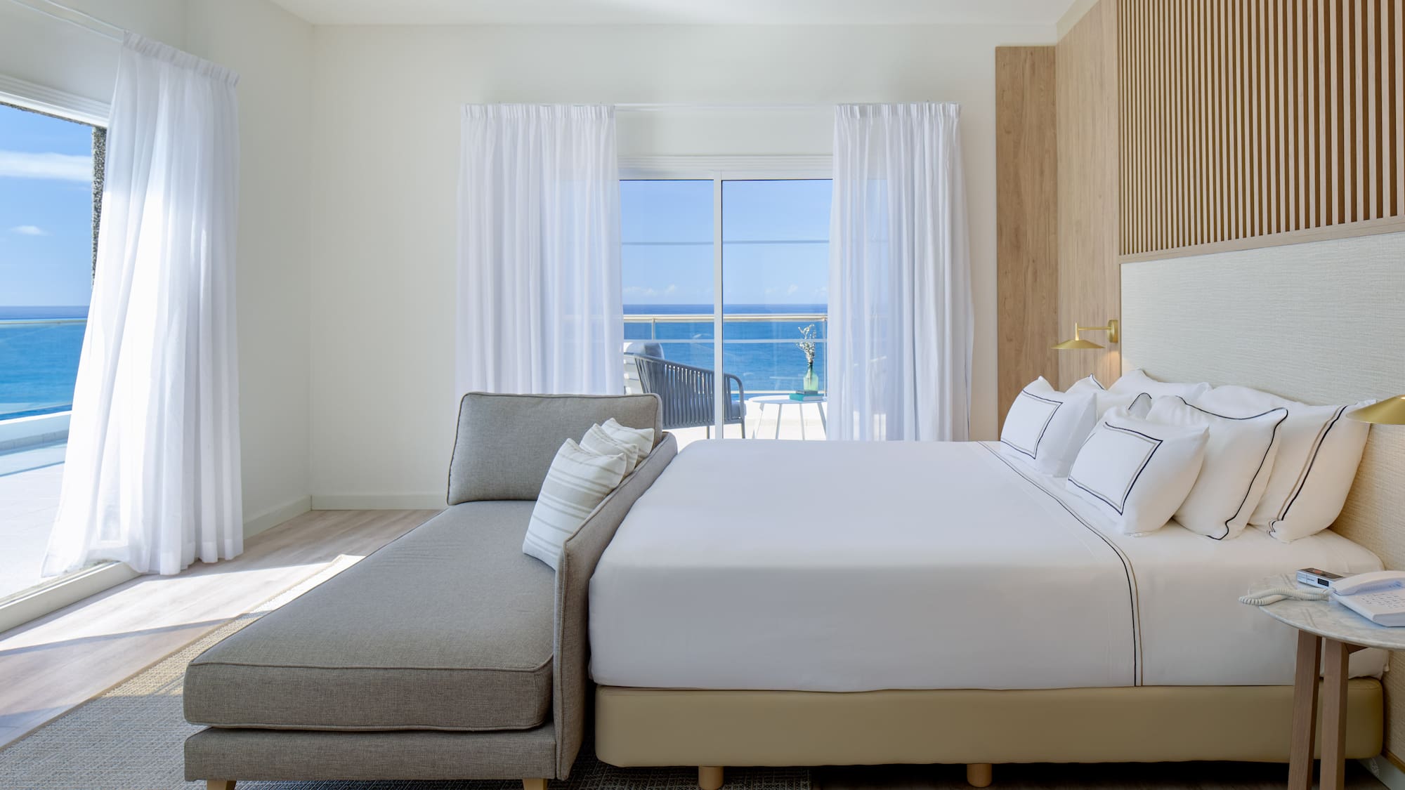 a bed in a room with a couch and a window