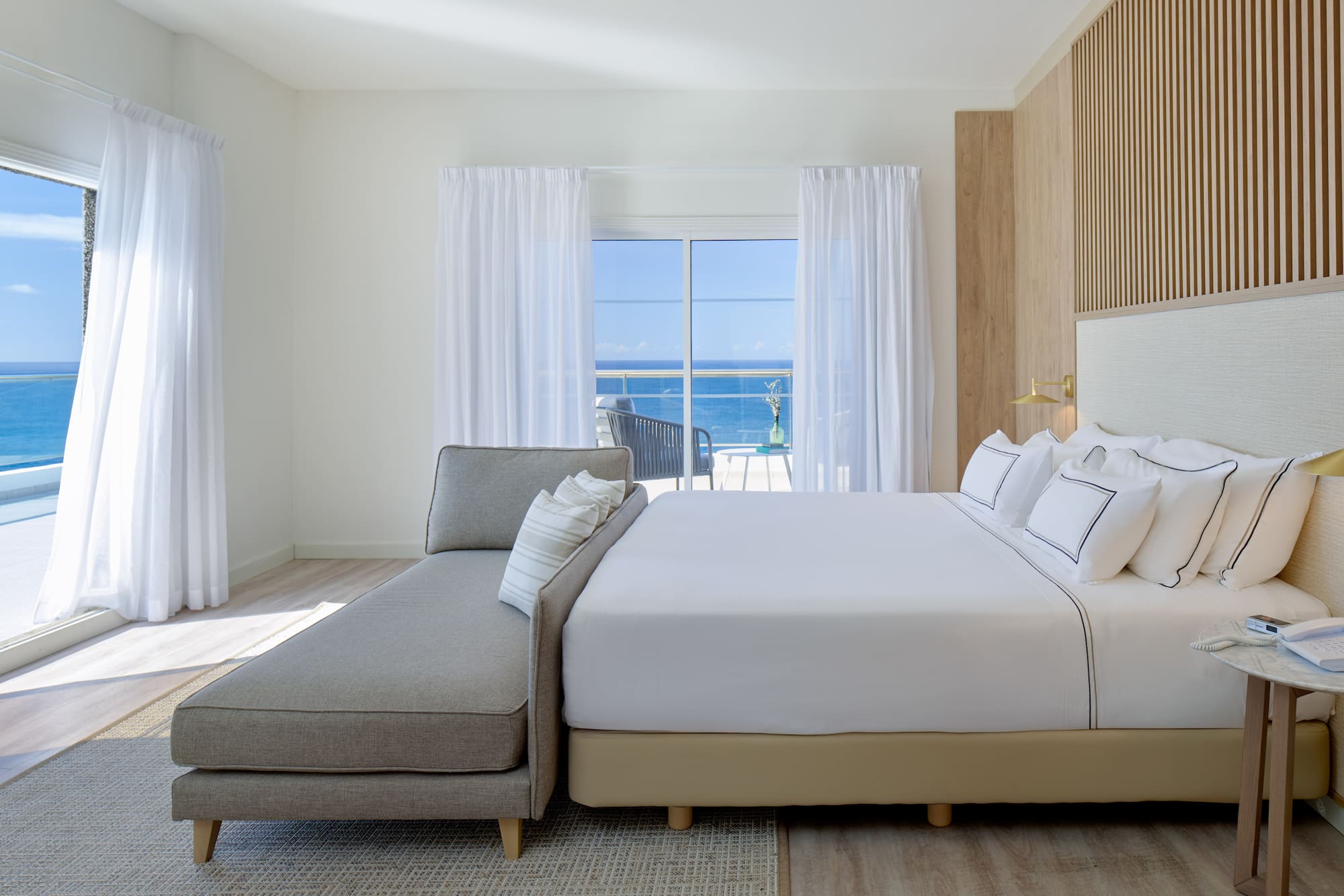 a bed in a room with a couch and a window