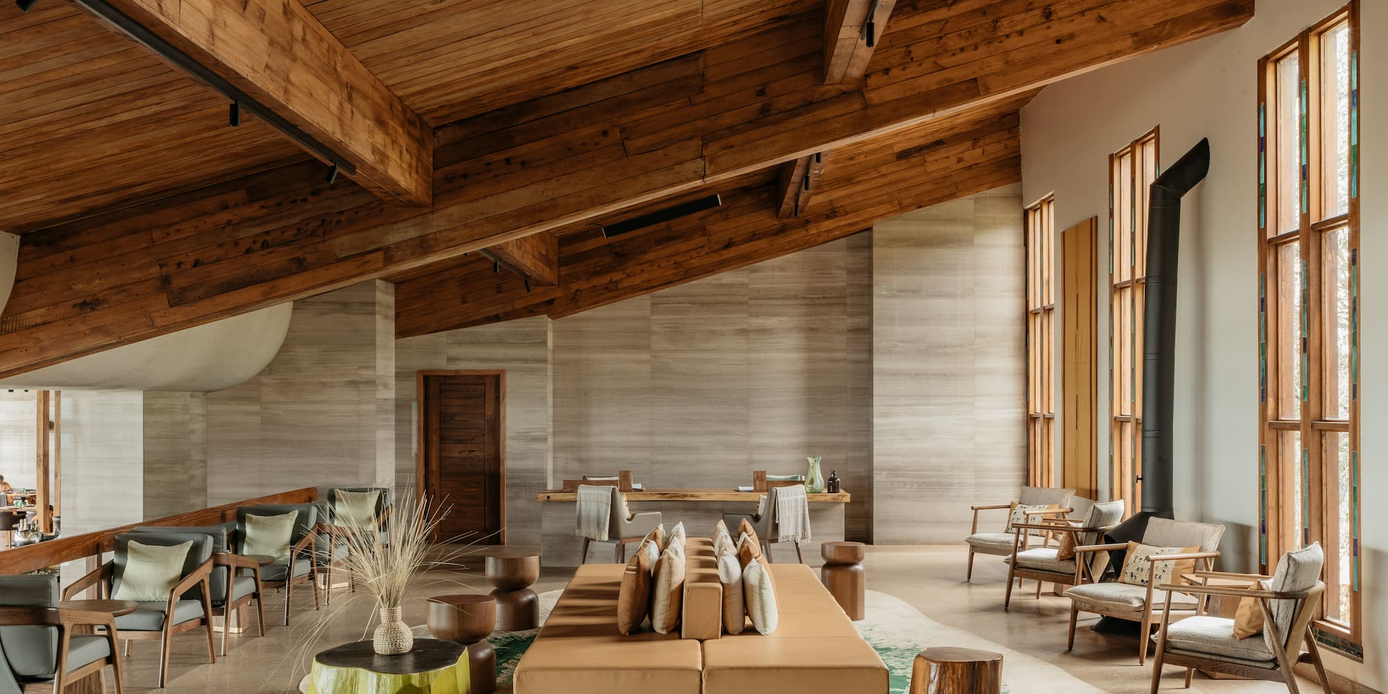 a room with a large couch and chairs