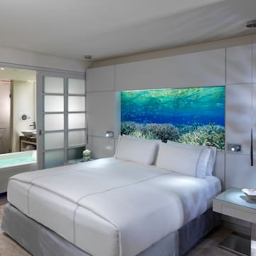 a bed with a fish tank in the wall