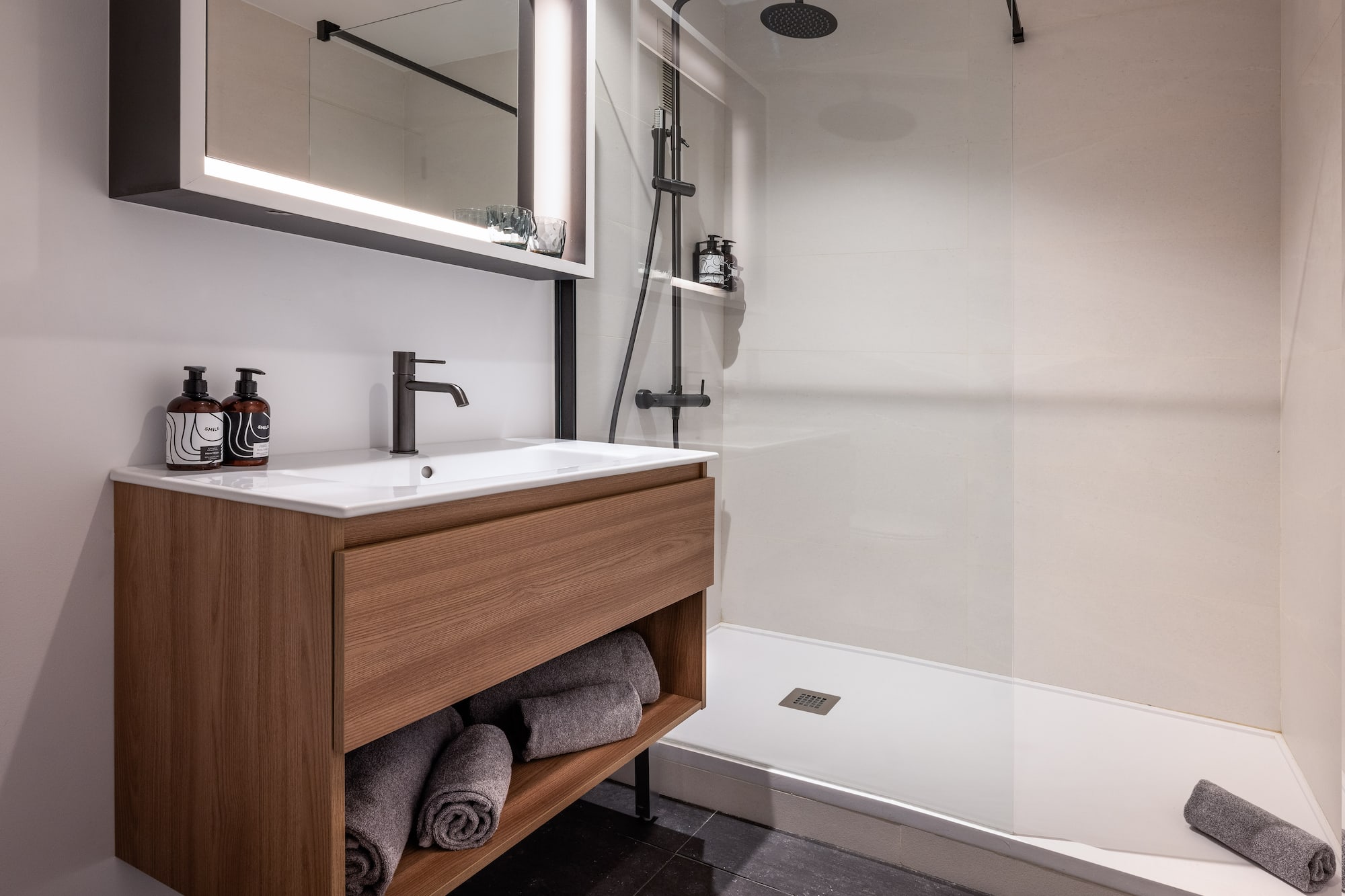 a bathroom with a shower and a sink