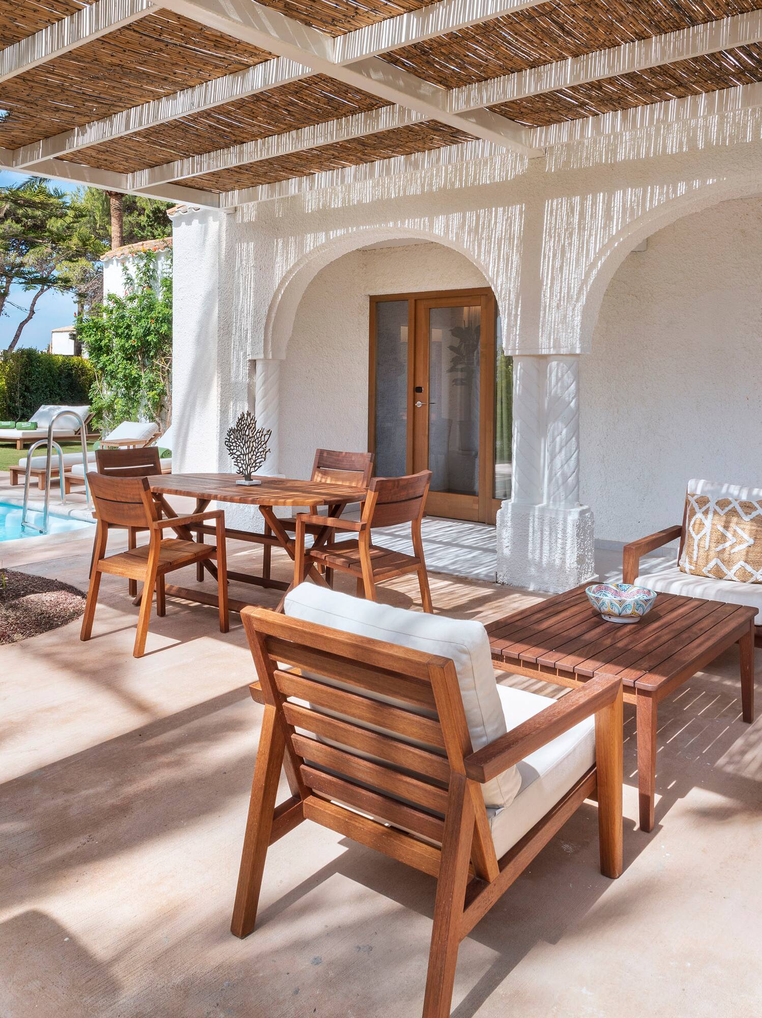 a patio with a table and chairs