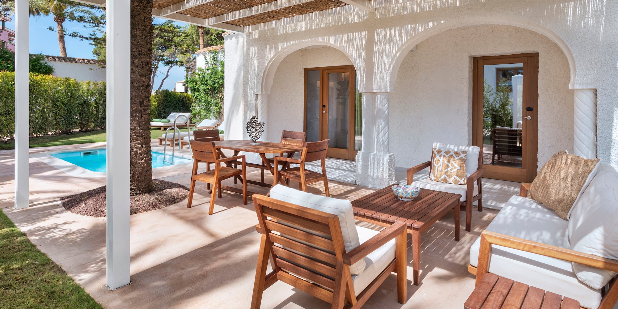 a patio with a table and chairs