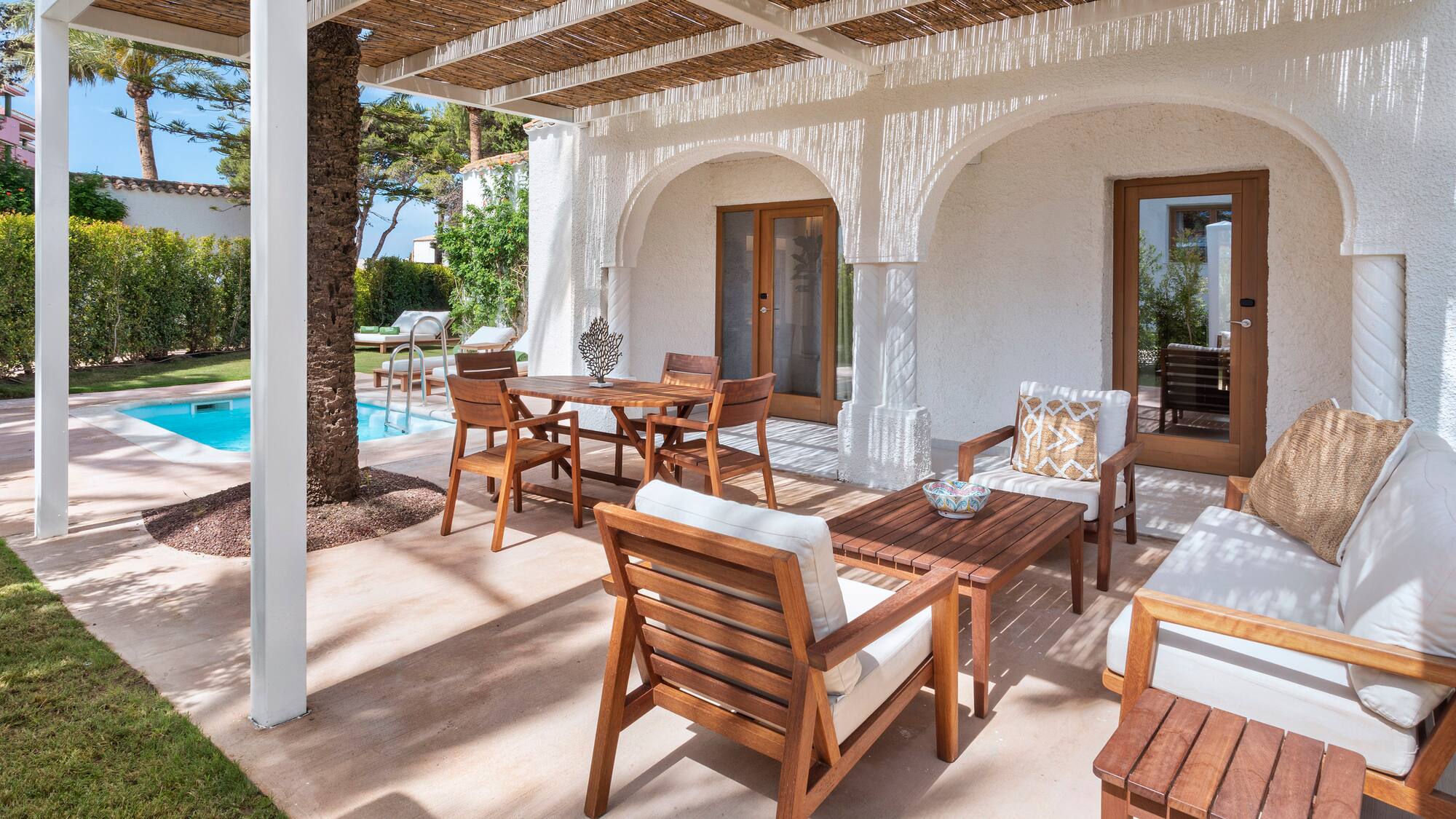 a patio with a table and chairs