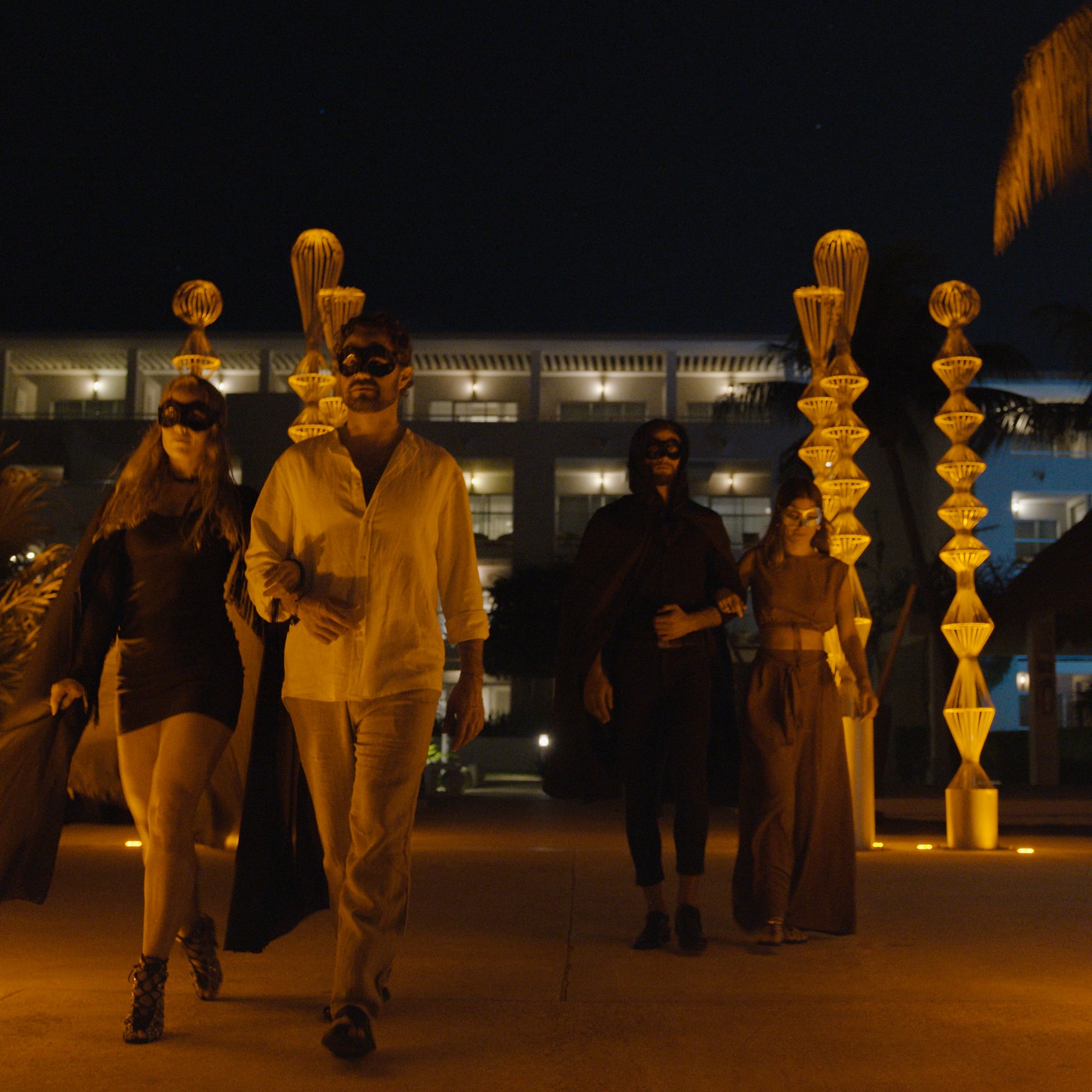 a group of people walking in front of a building