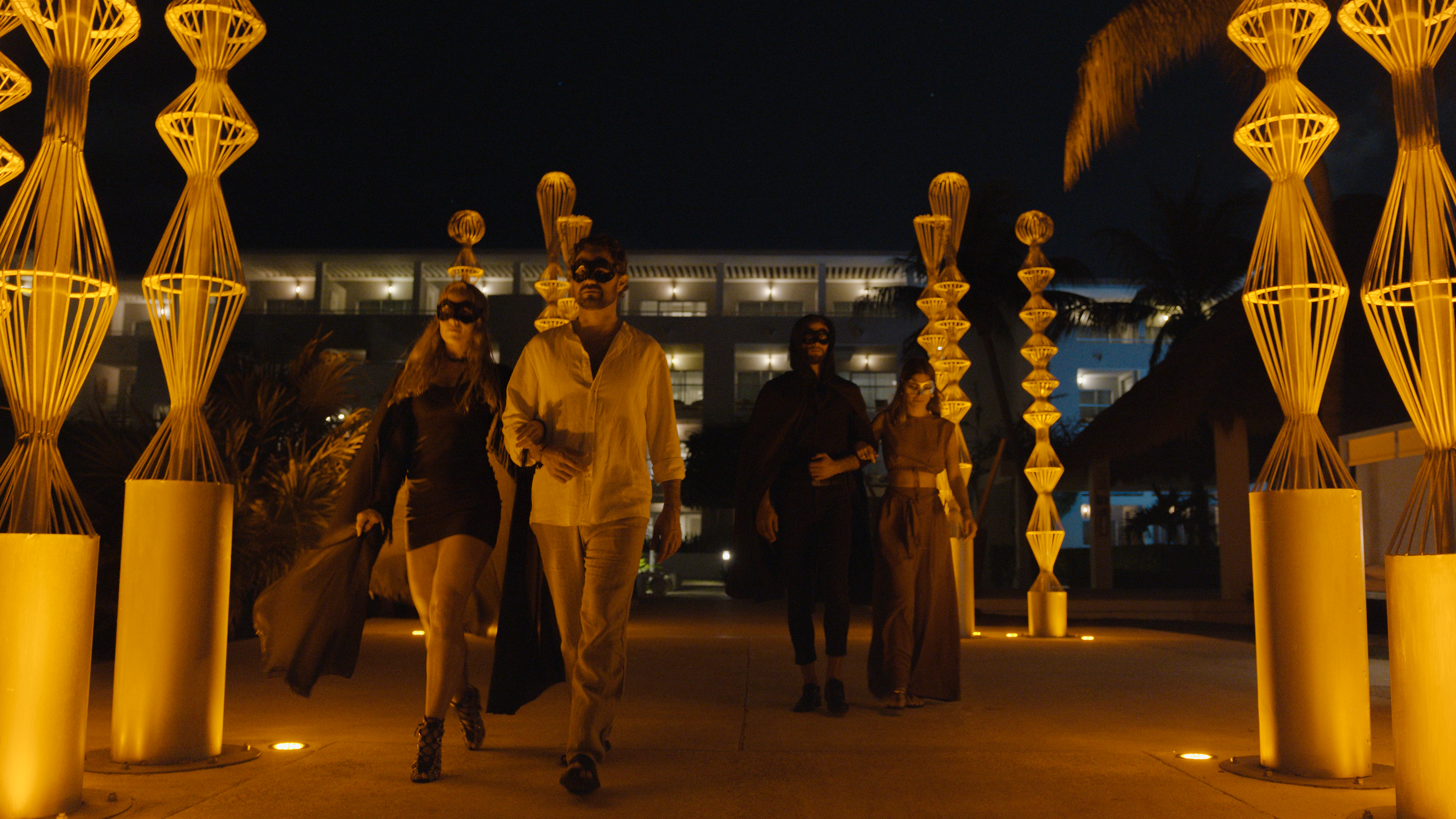 a group of people walking in front of a building