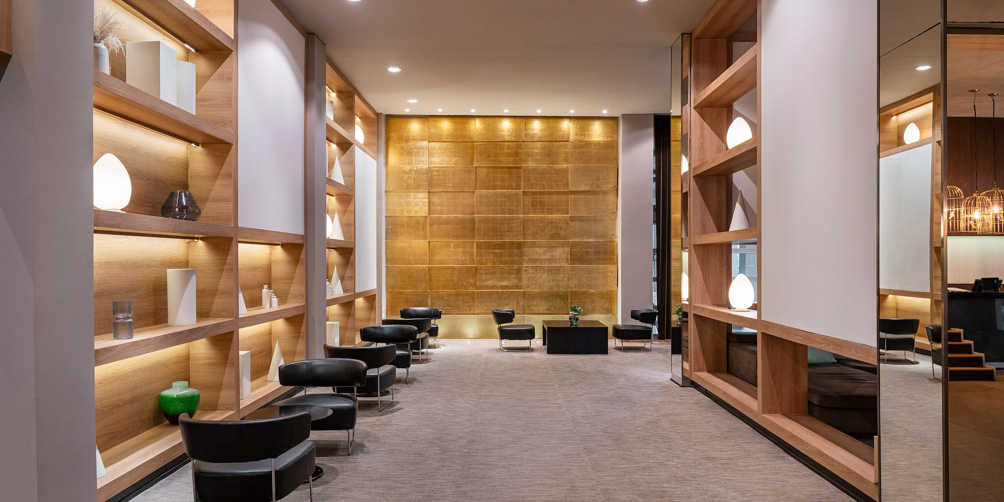 a room with a row of chairs and shelves