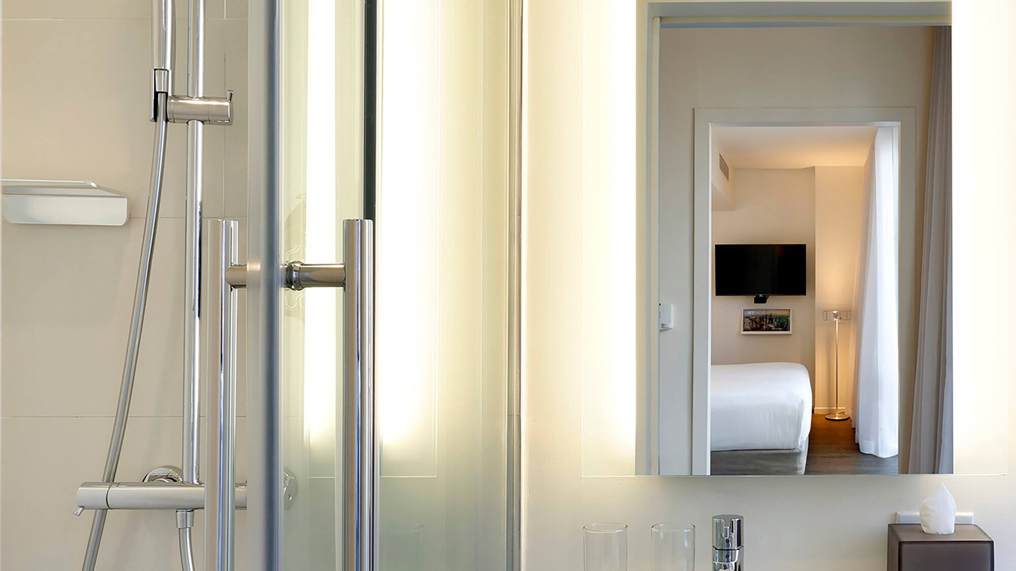 a bathroom with a shower and a mirror