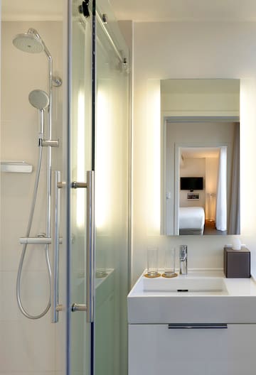 a bathroom with a shower and a mirror