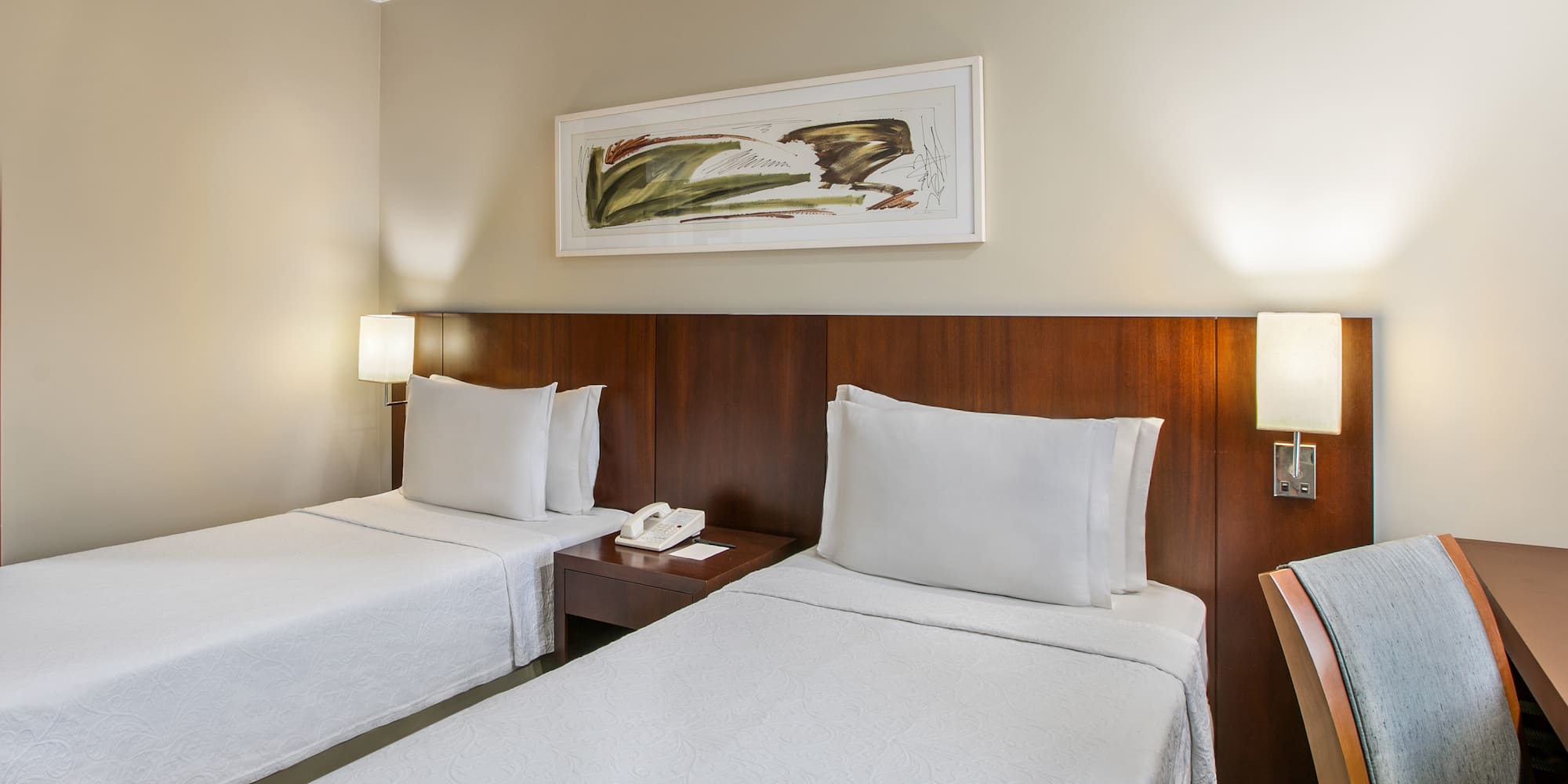 a room with two beds and a telephone