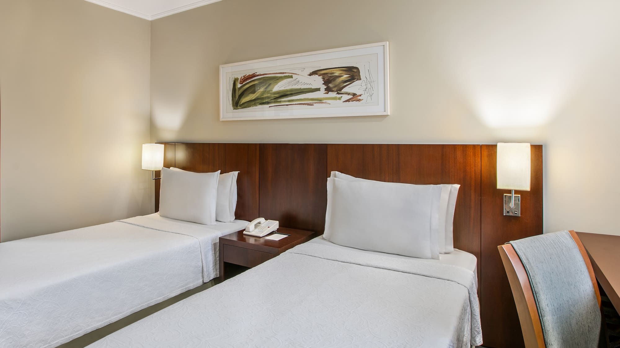 a room with two beds and a telephone